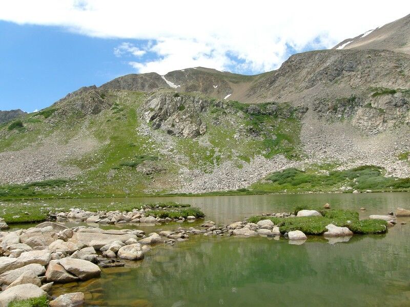 The trail climbs gradually through colorful meadows and ends at a beautiful alpine lake. Photo Credit: Vicki Devine (Flickr).