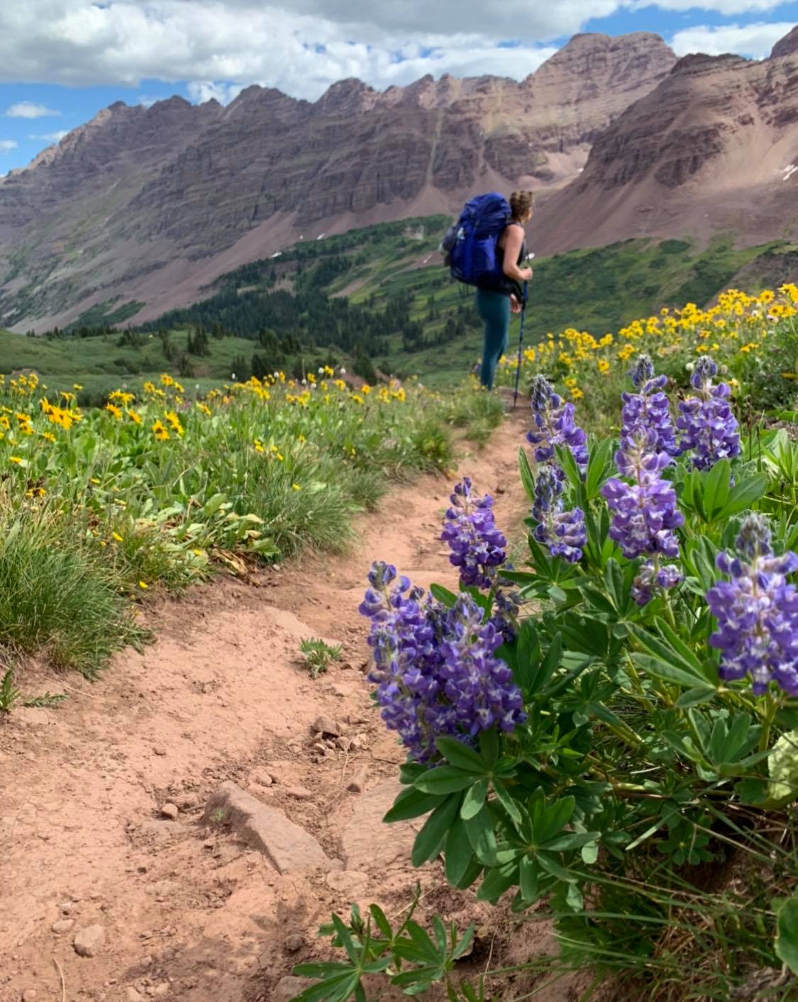 Breanna Sneeringer, of OutThere Colorado, takes in the sweeping views of the mountains. Photo Credit: Ashley Bennett.