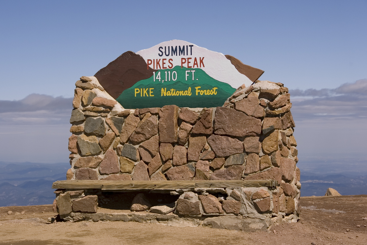 The summit sign is a popular spot for snapping photographs on top of Pikes Peak. Photo Credit: GaryLHampton (iStock). (GaryLHampton)