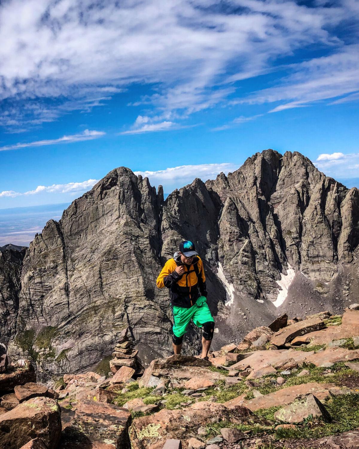 Spencer McKee of Outthere Colorado in front of Crestone Needle and Crestone Peak