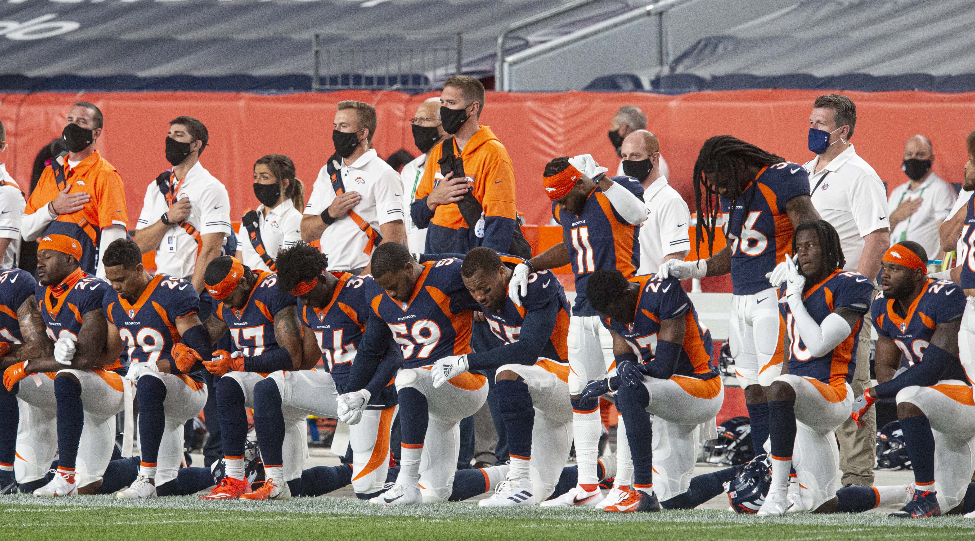 Members of the Denver Broncos kneel for the National Anthem before the start of their game against the Tennessee Titans Monday, Sept. 14, 2020, at Empower Field at Mile High in Denver. (The Gazette, Christian Murdock) (Christian Murdock/The Gazette)