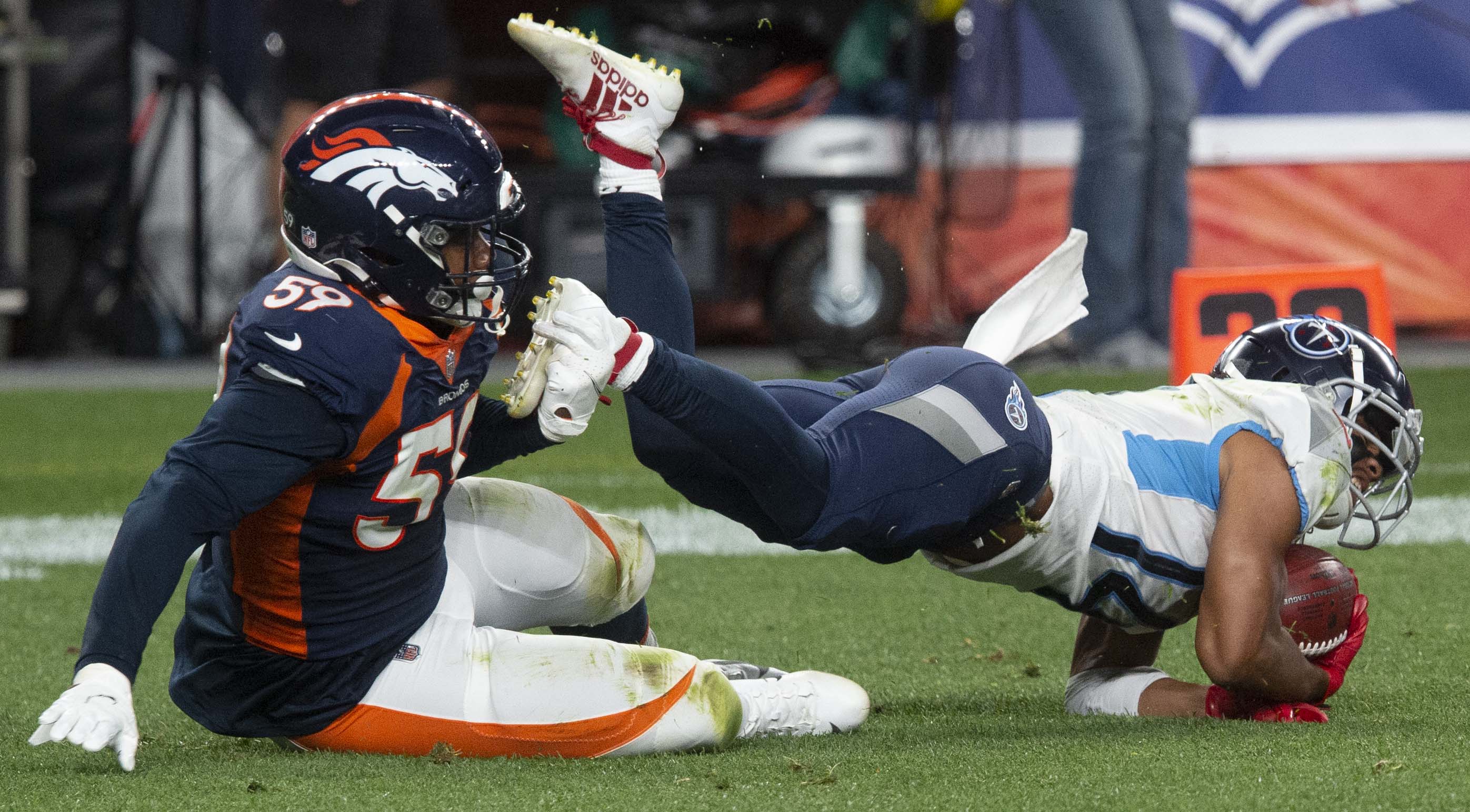 Denver Broncos linebacker Malik Reed (59) tackles Tennessee Titans wide receiver Kalif Raymond (14) during the third quarter Monday, Sept. 14, 2020, at Empower Field at Mile High in Denver.The Titans won 16-14. (The Gazette, Christian Murdock) (Christian Murdock/The Gazette)