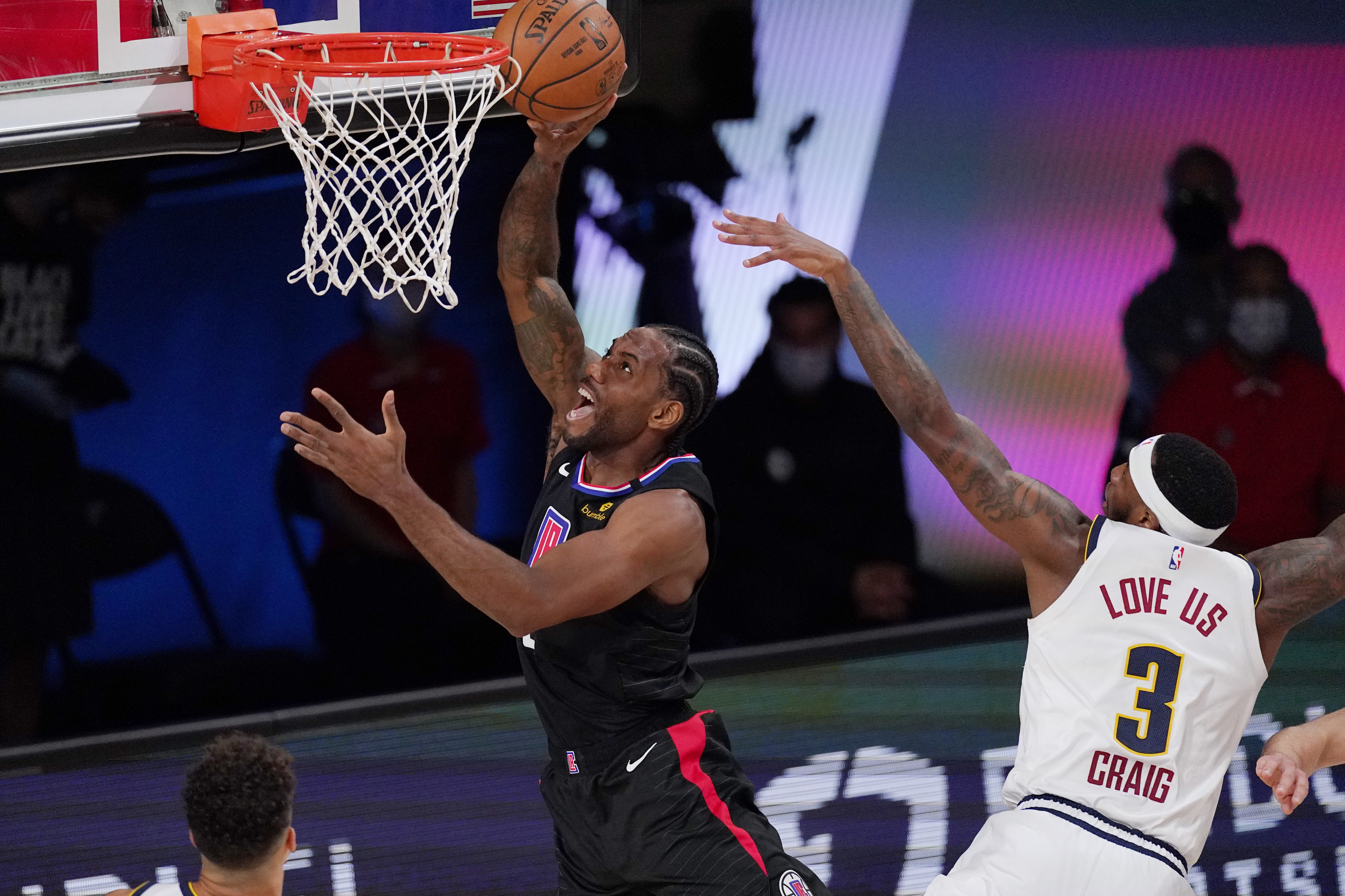 Los Angeles Clippers' Kawhi Leonard (2) shoots in front of Denver Nuggets' Torrey Craig (3) in the first half of an NBA conference semifinal playoff basketball game Thursday, Sept 3, 2020, in Lake Buena Vista Fla. (AP Photo/Mark J. Terrill) (Mark J. Terrill)