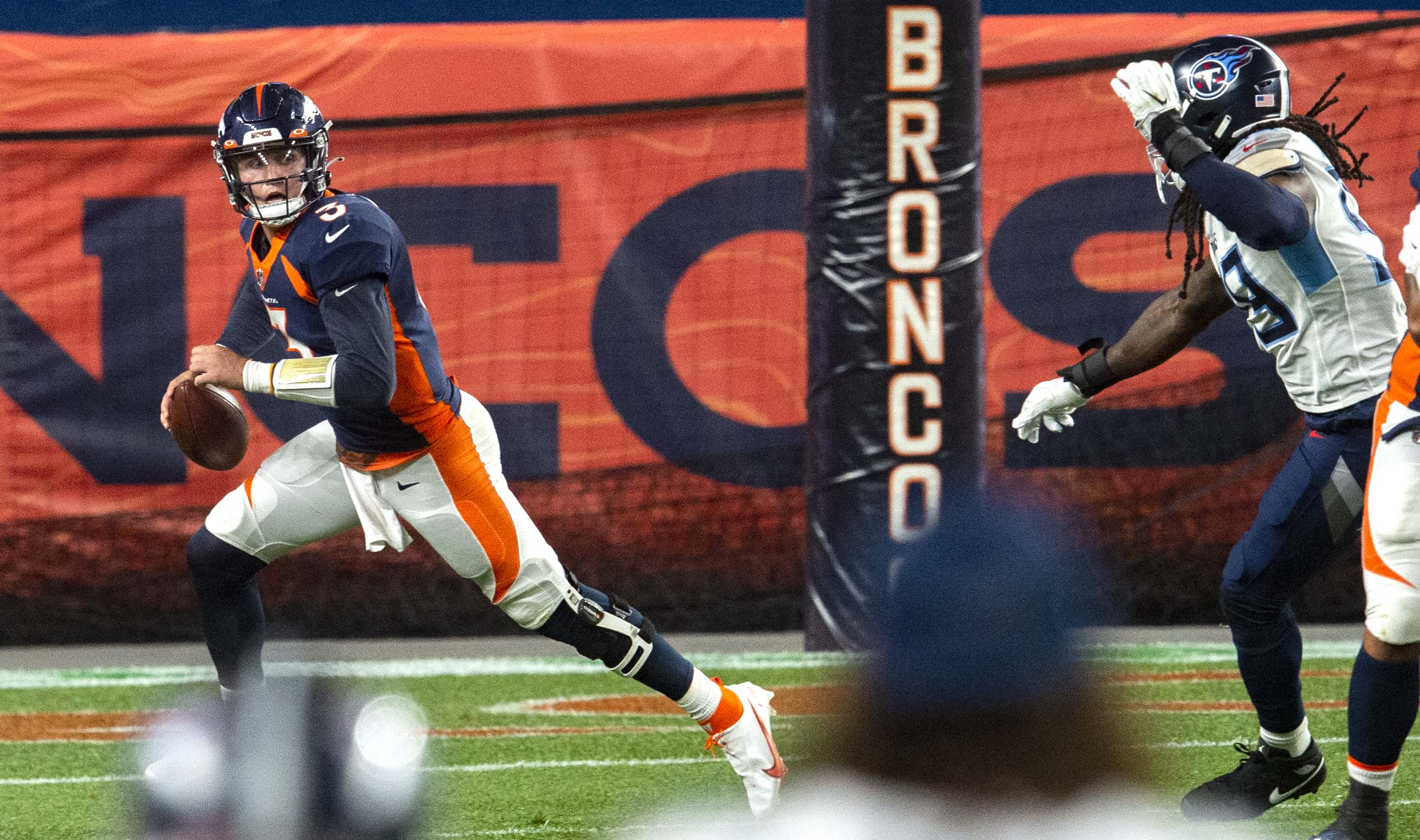 Denver Broncos quarterback Drew Lock (3) runs from the pressure of Titans outside linebacker Jadeveon Clowney during the second quarter Monday, Sept. 14, 2020, at Empower Field at Mile High in Denver. (The Gazette, Christian Murdock) (Christian Murdock/The Gazette)