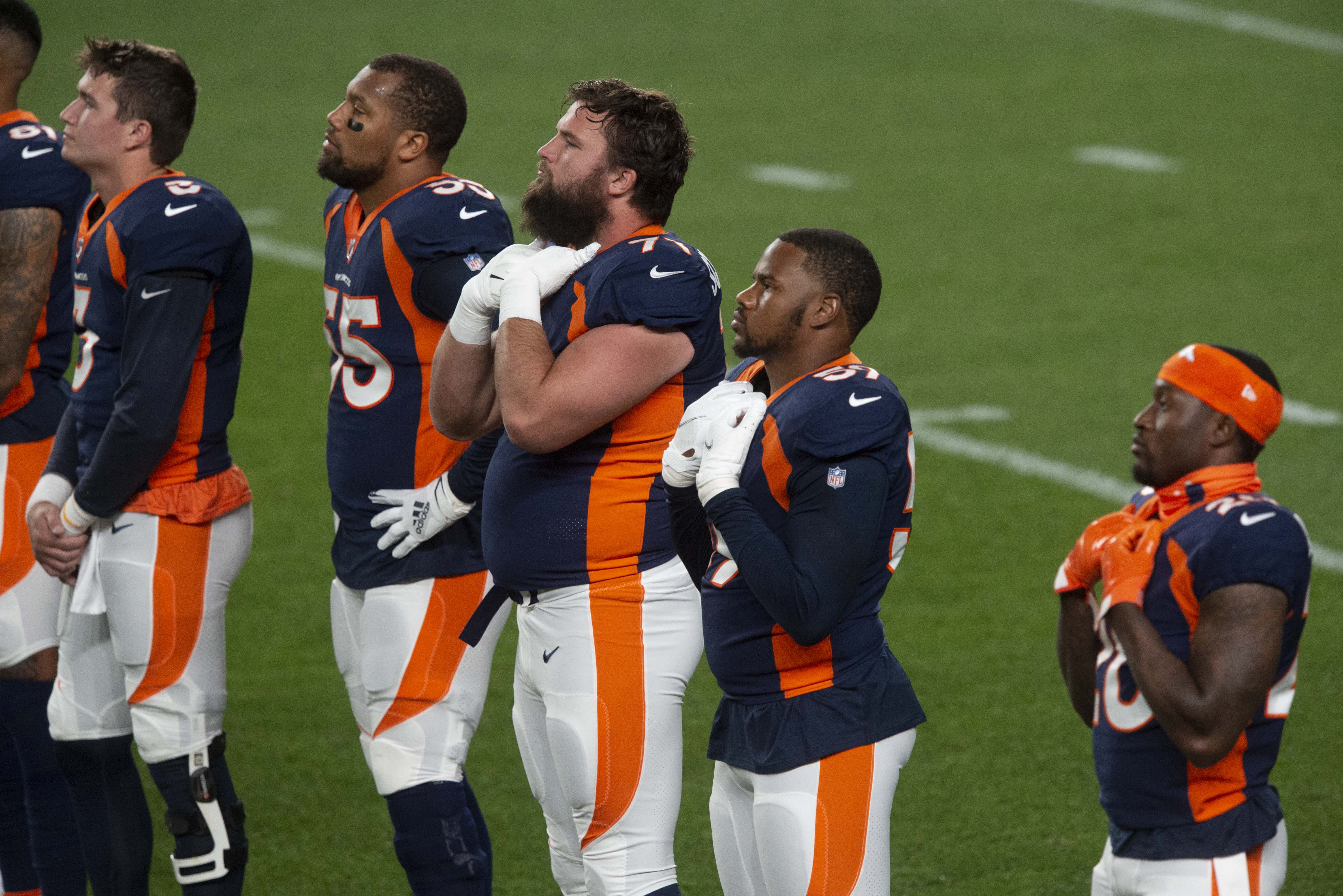 Denver Broncos players join the Titan players at midfield before leaving the field after pregame activities as a anti-racism video is played on the big screen Monday, Sept. 14, 2020, at Empower Field at Mile High in Denver. (The Gazette, Christian Murdock) (Christian Murdock/The Gazette)