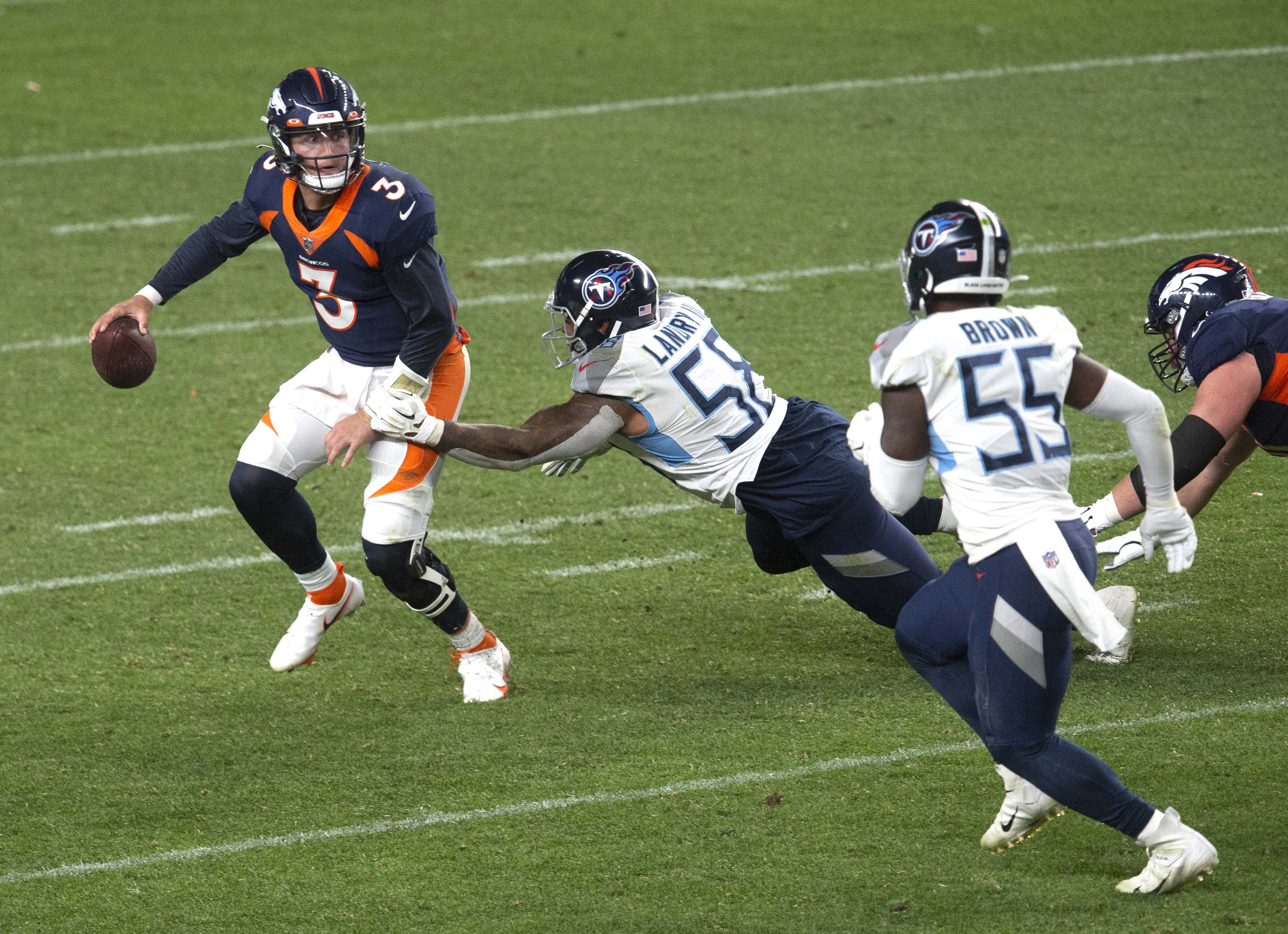 Denver Broncos quarterback Drew Lock (3) tries to shake Tennessee Titans linebacker Harold Landry (58) during the fourth quarter Monday, Sept. 14, 2020, at Empower Field at Mile High in Denver.The Titans won 16-14. (The Gazette, Christian Murdock) (Christian Murdock/The Gazette)