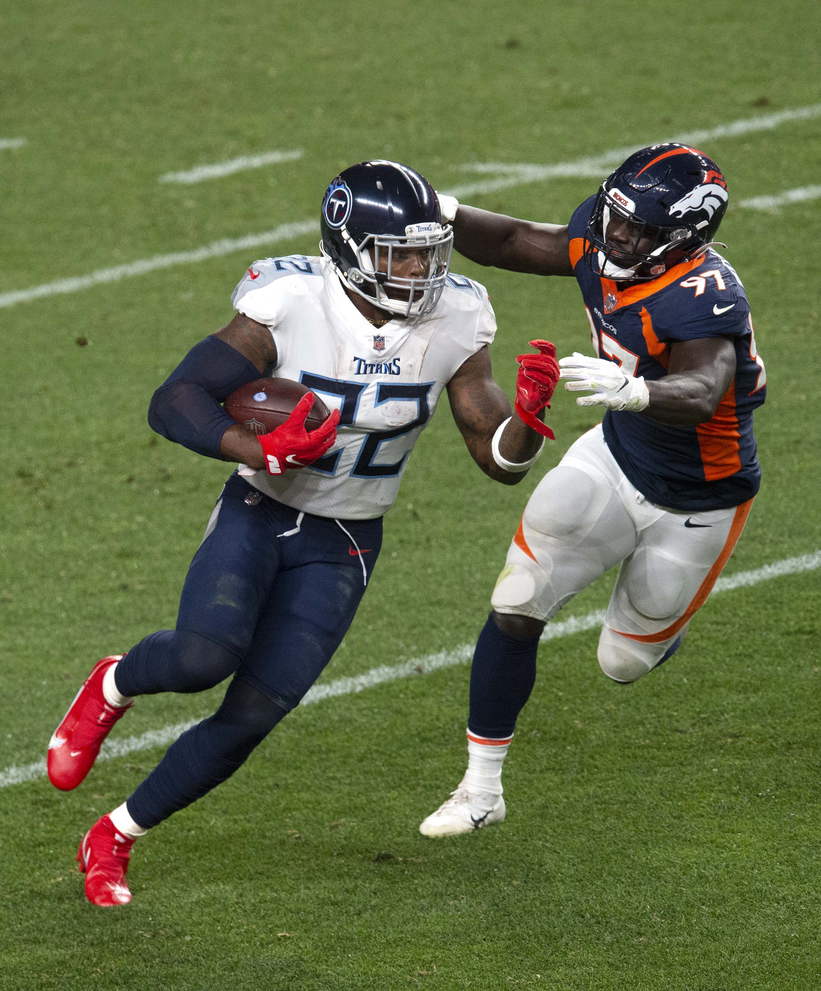 Tennessee Titans running back Derrick Henry (22) runs past Denver Broncos linebacker Jeremiah Attaochu (97)f for a first down during the third quarter Monday, Sept. 14, 2020, at Empower Field at Mile High in Denver.The Titans won 16-14. (The Gazette, Christian Murdock) (Christian Murdock/The Gazette)