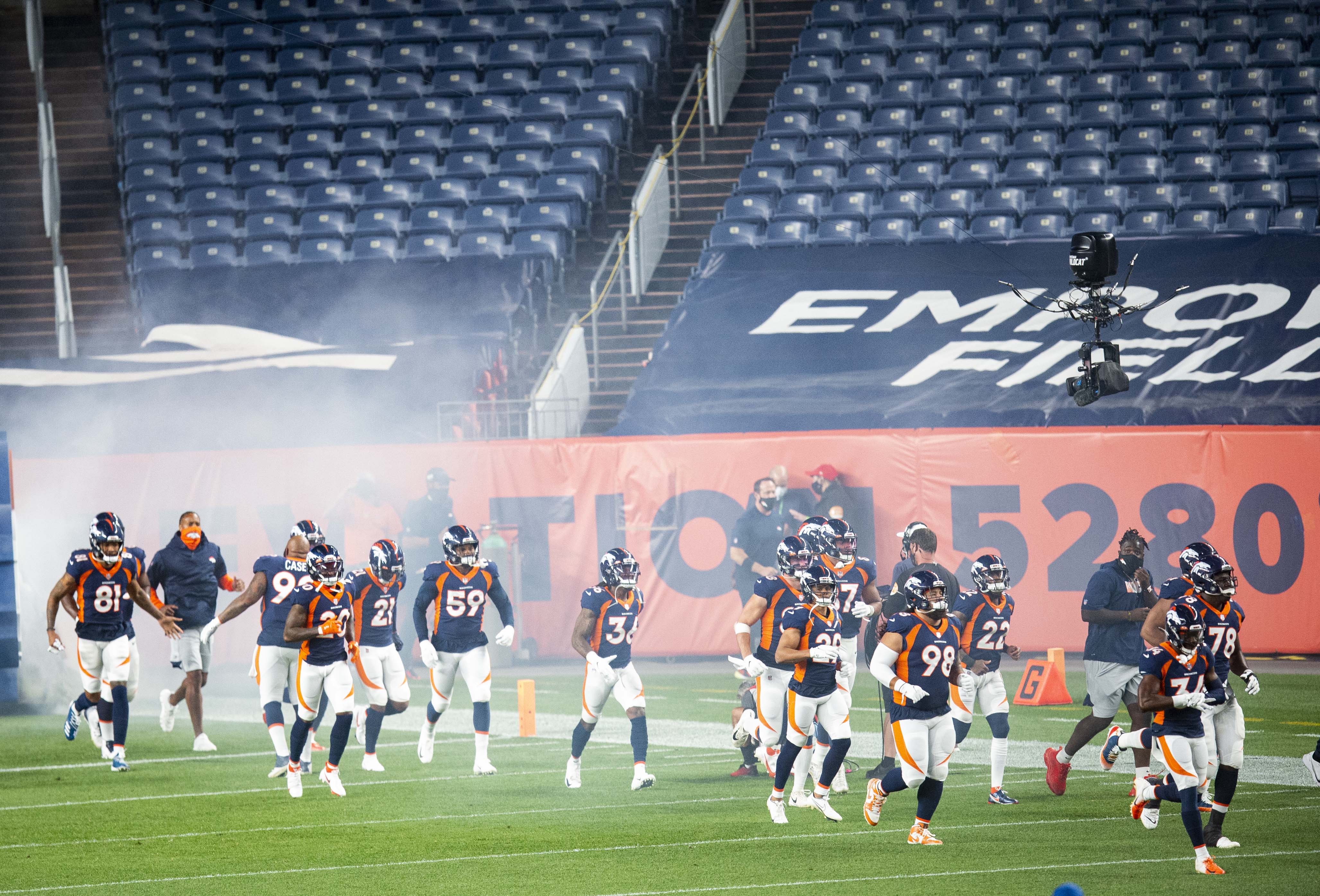 The Denver Broncos run into an empty stadium for the start of their game against the Tennessee Titans Monday, Sept. 14, 2020, at Empower Field at Mile High in Denver. (The Gazette, Christian Murdock) (Christian Murdock/The Gazette)