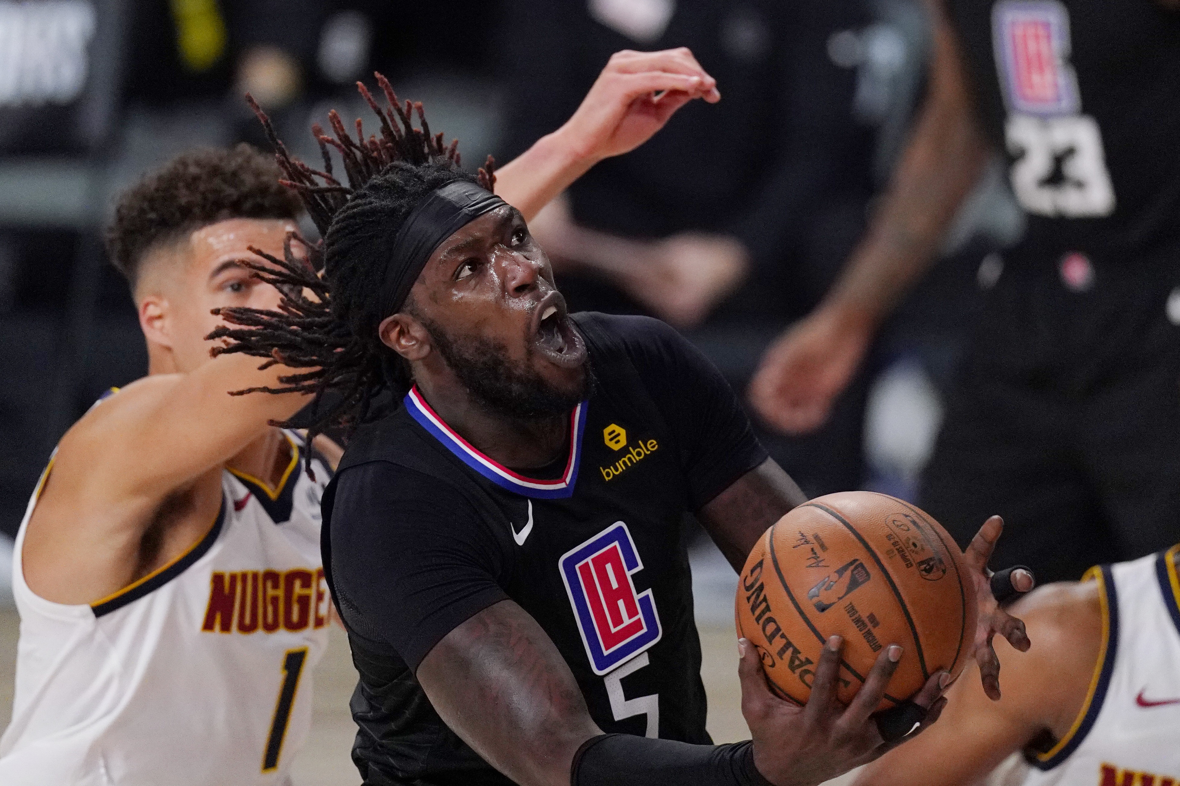 Los Angeles Clippers' Montrezl Harrell (5) drives to the basket past Denver Nuggets' Michael Porter Jr. (1) in the second half of an NBA conference semifinal playoff basketball game Thursday, Sept 3, 2020, in Lake Buena Vista Fla. (AP Photo/Mark J. Terrill) (Mark J. Terrill)
