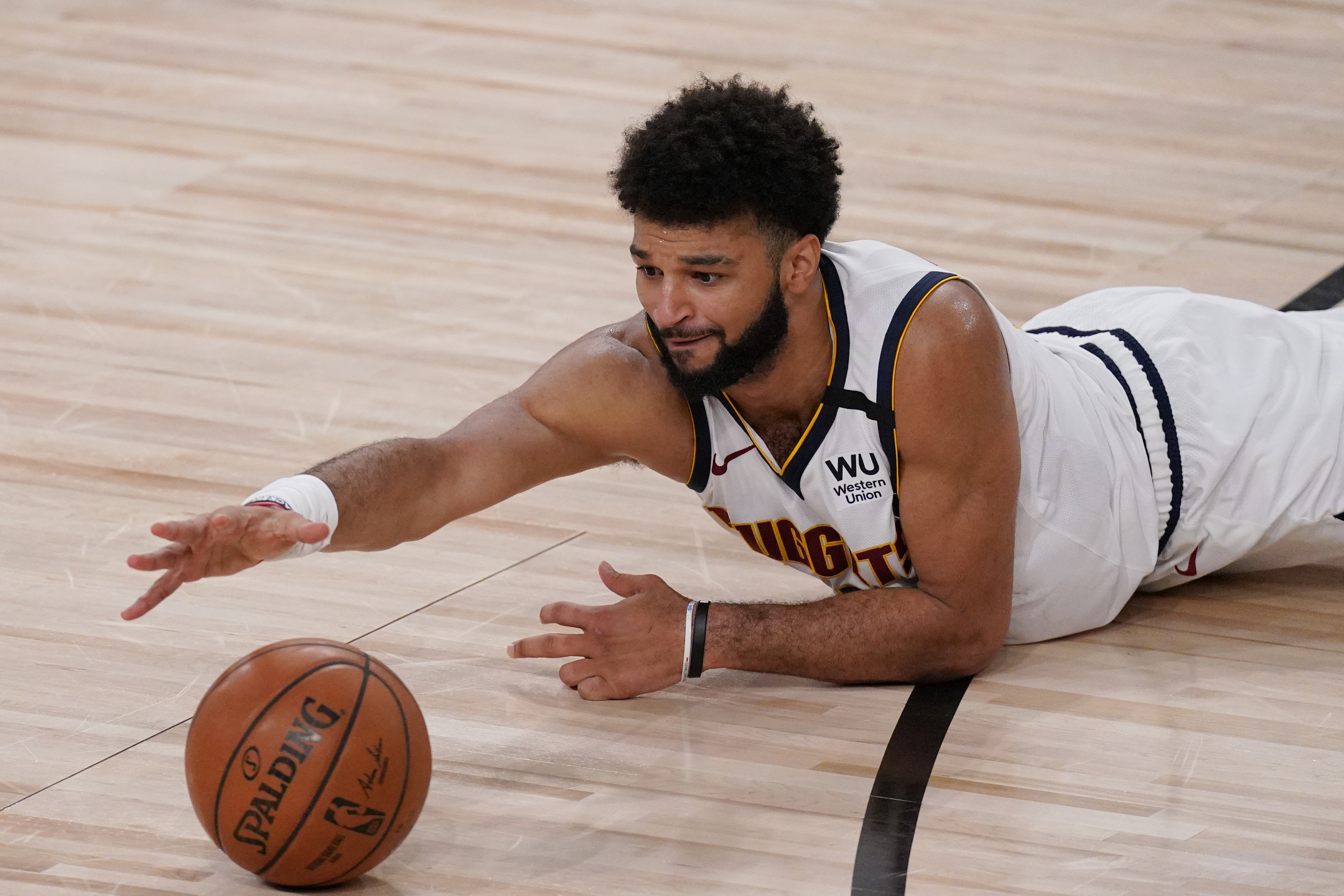 Denver Nuggets' Jamal Murray (27)n reaches for the ball in the first half of an NBA conference semifinal playoff basketball game against the Los Angeles Clippers Thursday, Sept 3, 2020, in Lake Buena Vista Fla. (AP Photo/Mark J. Terrill) (Mark J. Terrill)