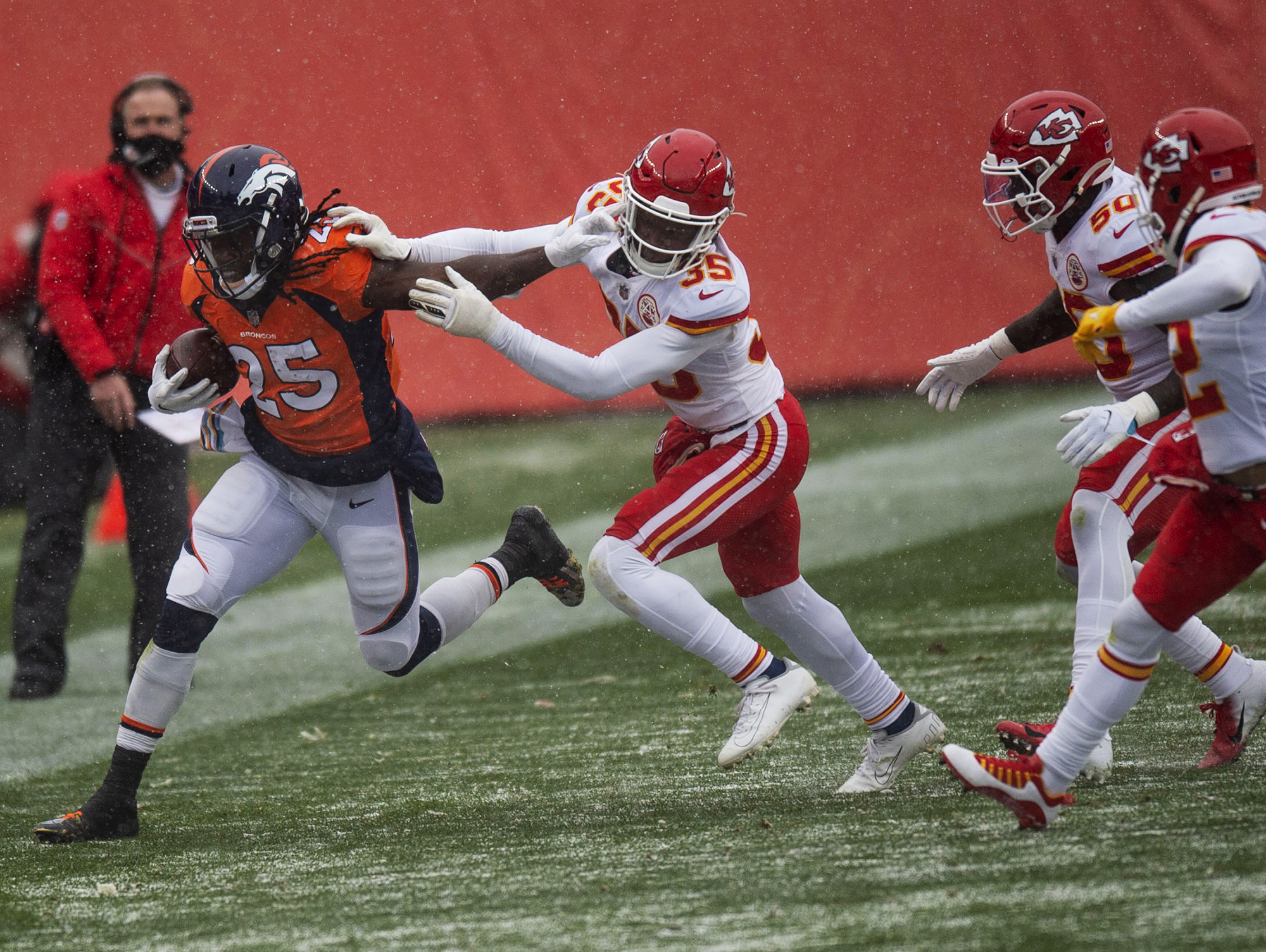 Denver Broncos running back Melvin Gordon III (25) is ran out of bounds by Kansas City Chiefs cornerback Charvarius Ward (35) during the Denver Broncos home game against the Kansas City Chiefs at Empower Field at Mile High in Denver, Colo., on Sunday, Oct. 25, 2020. The Broncos lost to the Chiefs by a score of 43-16.(Chancey Bush/ The Gazette) (ChristianMurdock)