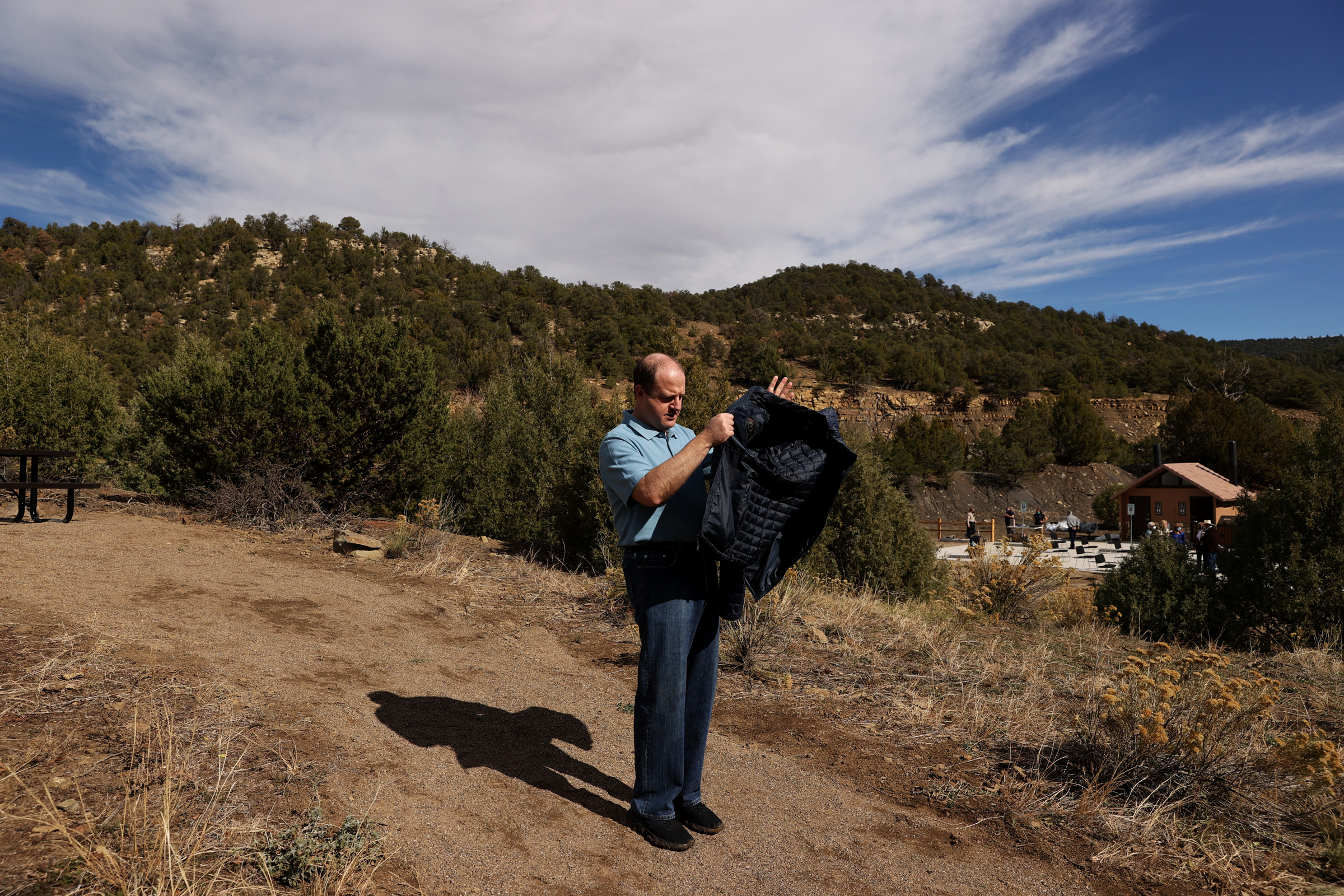 Colorado Governor Jared Polis searches for his face mask after a photo opportunity at the grand opening of Fishers Peak State Park near Trinidad, Colorado on Oct. 30, 2020. The governor signed an executive order at the ceremony, and the park officially opened to the public. (Forrest Czarnecki/The Gazette) (Forrest Czarnecki)