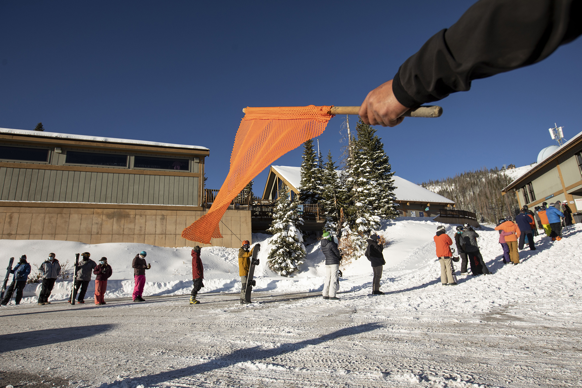 People line up for lift tickets at Wolf Creek Ski Area in Colorado on Wednesday, Oct. 28, 2020. Wolf Creek is the first ski area in Colorado to open for the 2020-21 season, with a snow total of 24 inches. Treasure, Bonanza and Nova lifts are in full operation. Due to COVID-19, all indoor facilities are closed, excluding bathrooms, social distancing and wearing of masks are required. (Chancey Bush/ The Gazette) (Chancey Bush The Gazette)