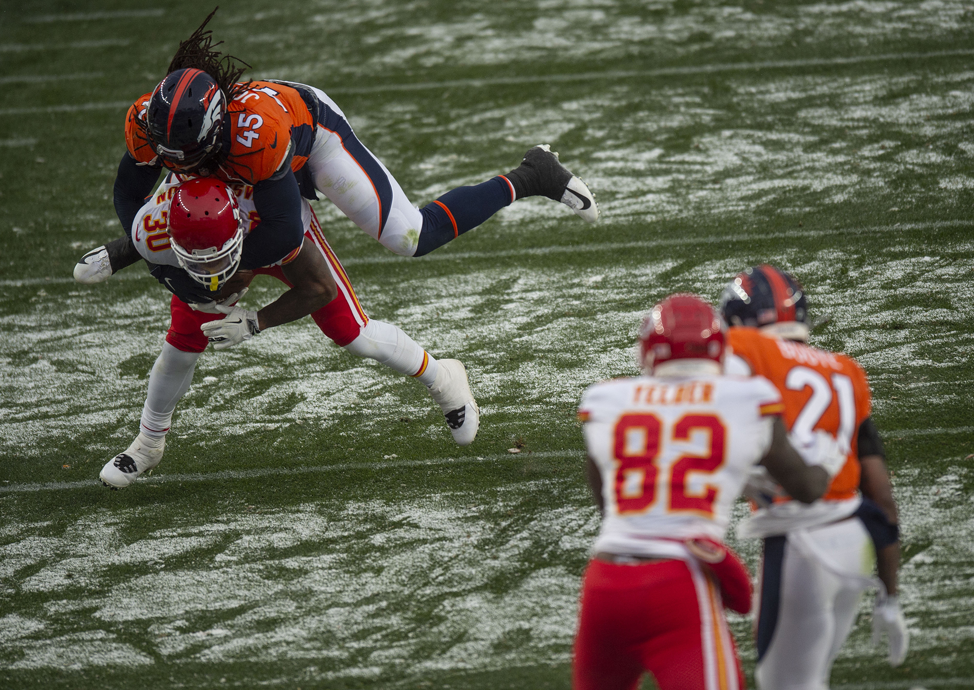 Denver Broncos inside linebacker A.J. Johnson (45) jumps on top of Kansas City Chiefs running back DeAndre Washington (30) during the Denver Broncos home game against the Kansas City Chiefs at Empower Field at Mile High in Denver, Colo., on Sunday, Oct. 25, 2020. The Broncos lost to the Chiefs by a score of 43-16.(Chancey Bush/ The Gazette) (ChristianMurdock)