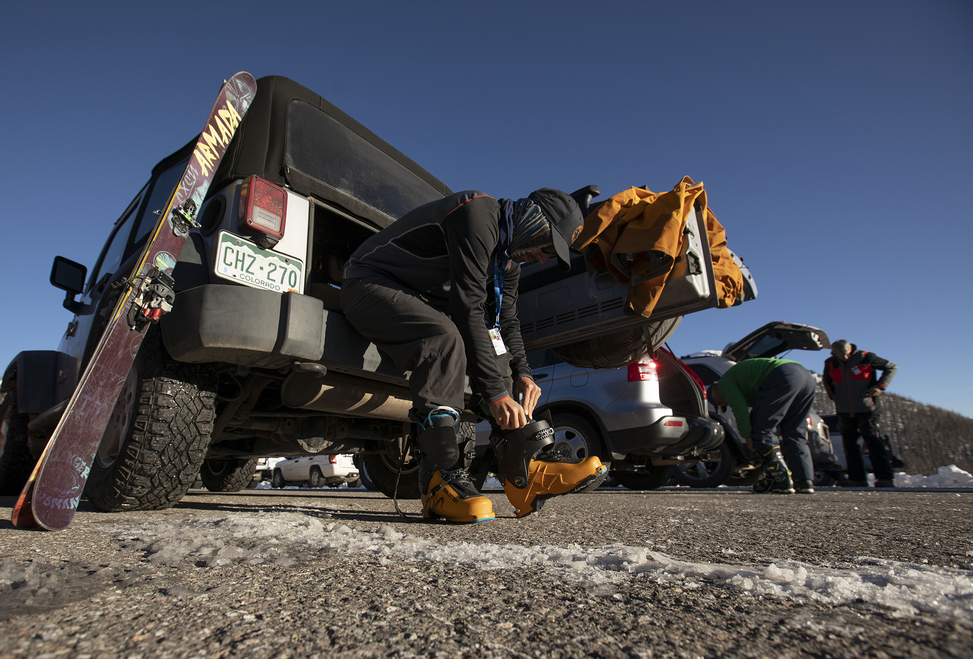 Nick Owen, resident of Del Norte, puts on his ski boots in the parking lot at Wolf Creek Ski Area in Colorado on Wednesday, Oct. 28, 2020. Wolf Creek is the first ski area in Colorado to open for the 2020-21 season, with a snow total of 24 inches. Treasure, Bonanza and Nova lifts are in full operation. Due to COVID-19, all indoor facilities are closed, excluding bathrooms, social distancing and wearing of masks are required. (Chancey Bush/ The Gazette) (Chancey Bush The Gazette)