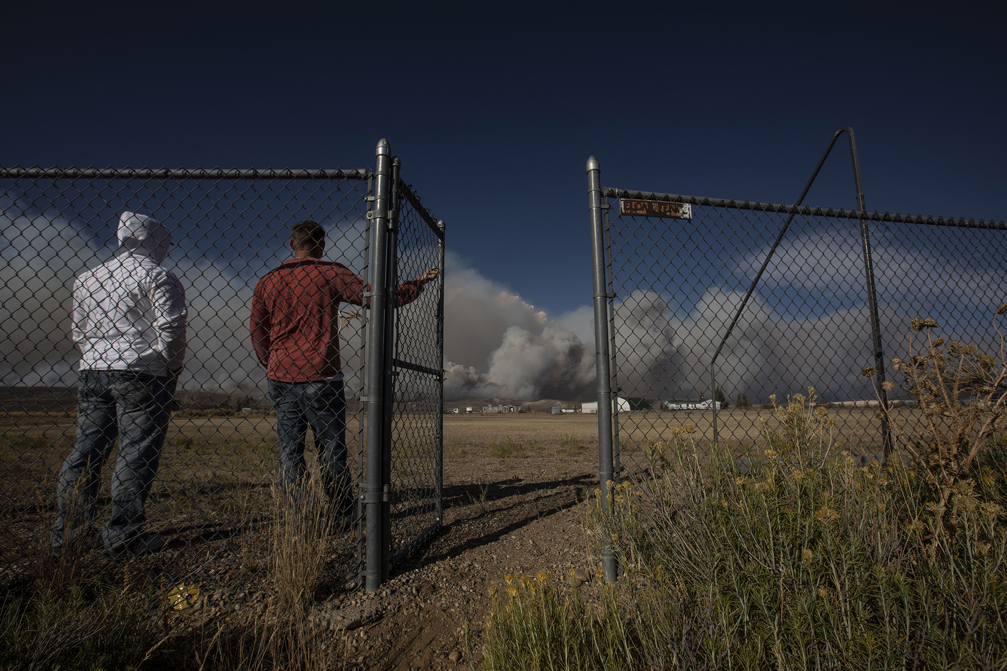 Brothers Joe and Michael Perizzolo watch the East Troublesome fire burn along the ridge in Granby, Colo., in Grand County on Thursday, Oct. 22, 2020. The East Troublesome fire has grown to be the second-largest wildfire in Colorado history. (Chancey Bush/ The Gazette) (Chancey Bush The Gazette)
