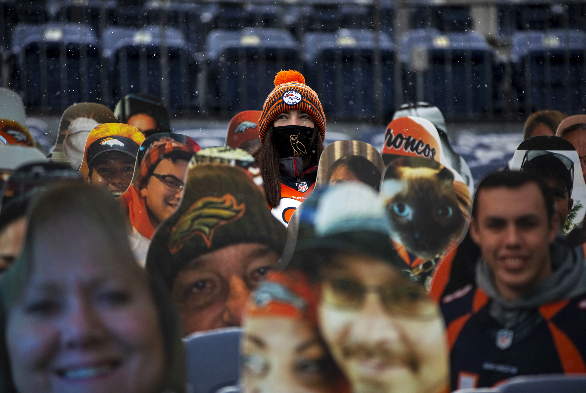 Alana Linford sits among fan cutouts in the stands before the start of the Denver Broncos home game against the Kansas City Chiefs at Empower Field at Mile High in Denver, Colo., on Sunday, Oct. 25, 2020. (Chancey Bush/ The Gazette) (Chancey Bush The Gazette)