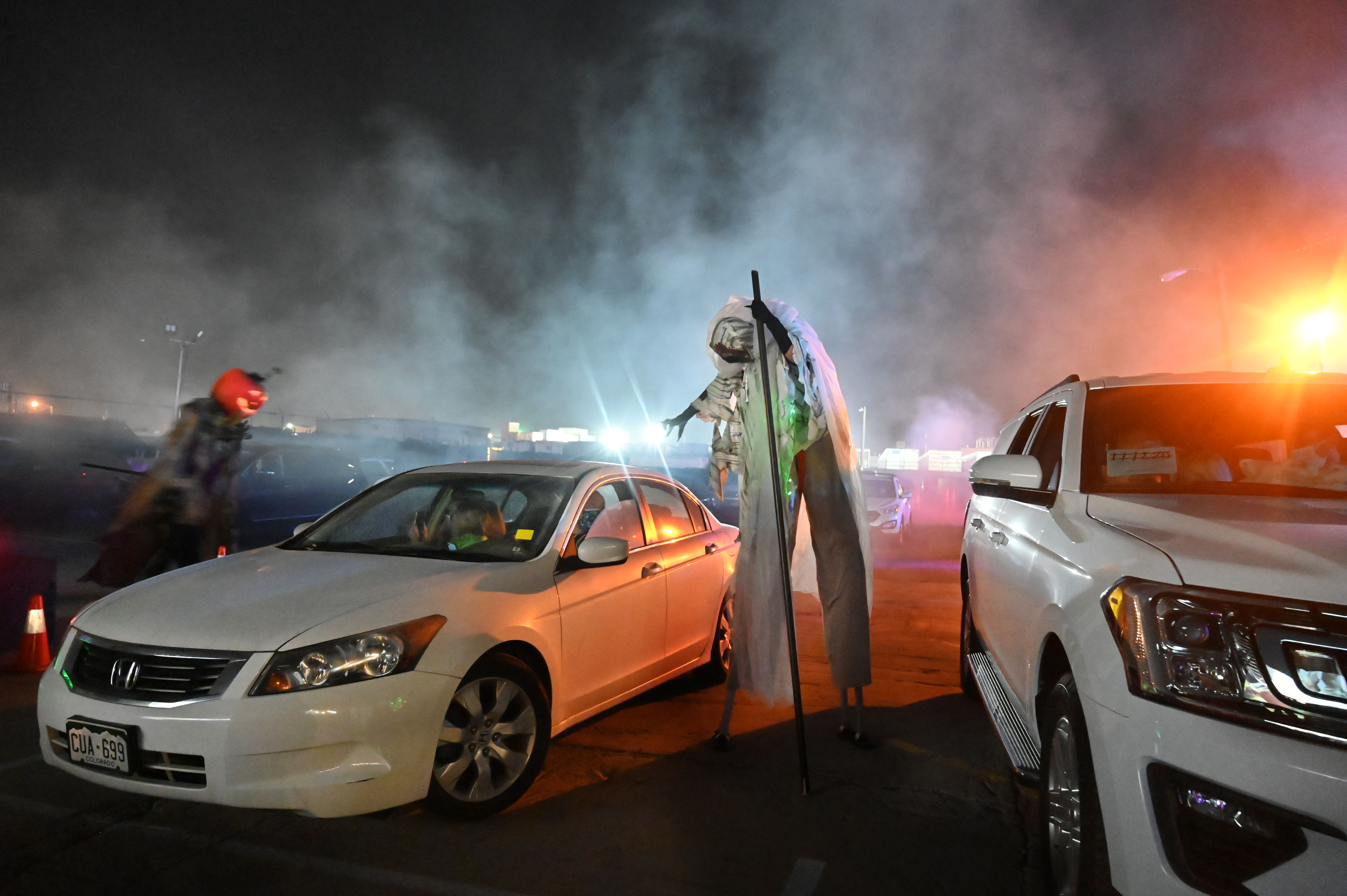 City of the Dead Drive-In is a way for visitors to get a haunted house type experience, without leaving the healthy comfort of their vehicle. A couple of ghouls haunt visitors in their cars while they watch a scary video on Wednesday, Oct. 21, 2020. (Photo by Jerilee Bennett, The Gazette) (JERILEE BENNETT THE GAZETTE)
