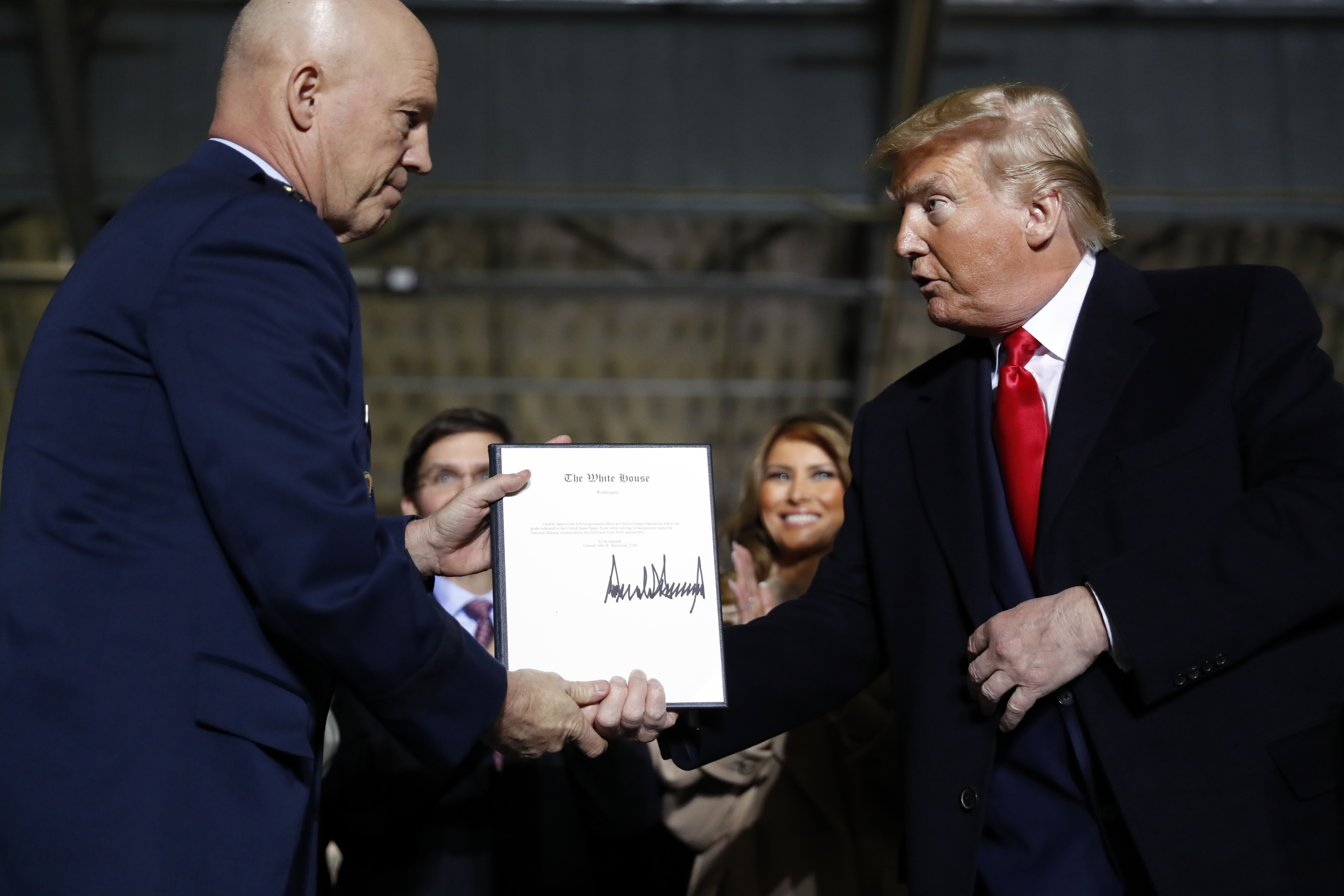 President Donald Trump shakes hands with Gen. Jay Raymond after signing the letter of his appointment as the chief of space operations for U.S. Space Command in December. The signing ceremony for the National Defense Authorization Act took place at Andrews Air Force Base, Md. (the associated press)