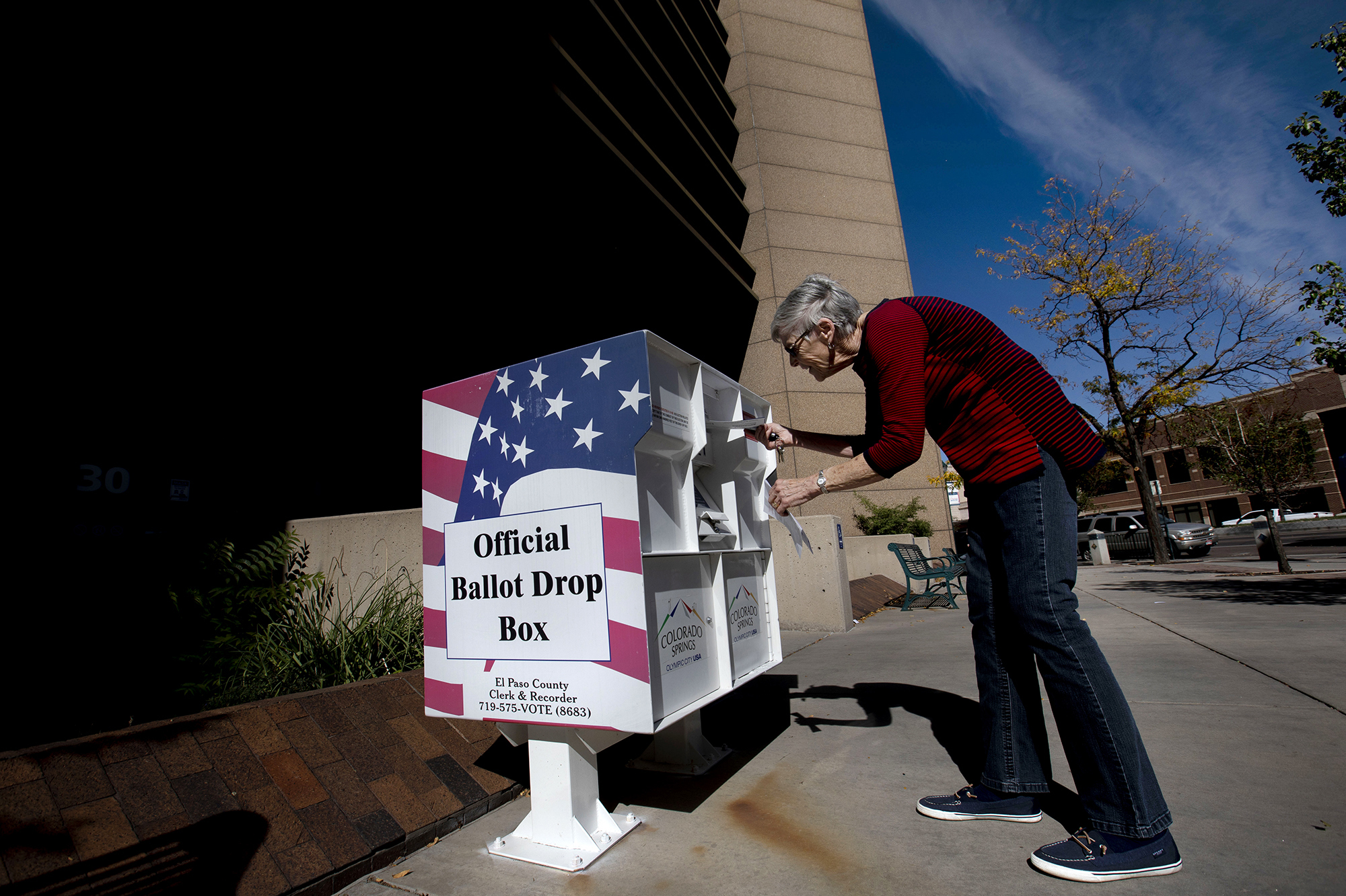 Eileen Reilly casts her vote into a drop box Wednesday outside the City Administration Building, 30 S. Nevada Ave., in Colorado Springs. Voters should be aware of their ballot signatures and sign their ballot envelopes, whether they are returned by mail or placed in a drop box. Ballots can be rejected if the voter’s signature does not match their signature on file. (Chancey Bush, The Gazette)