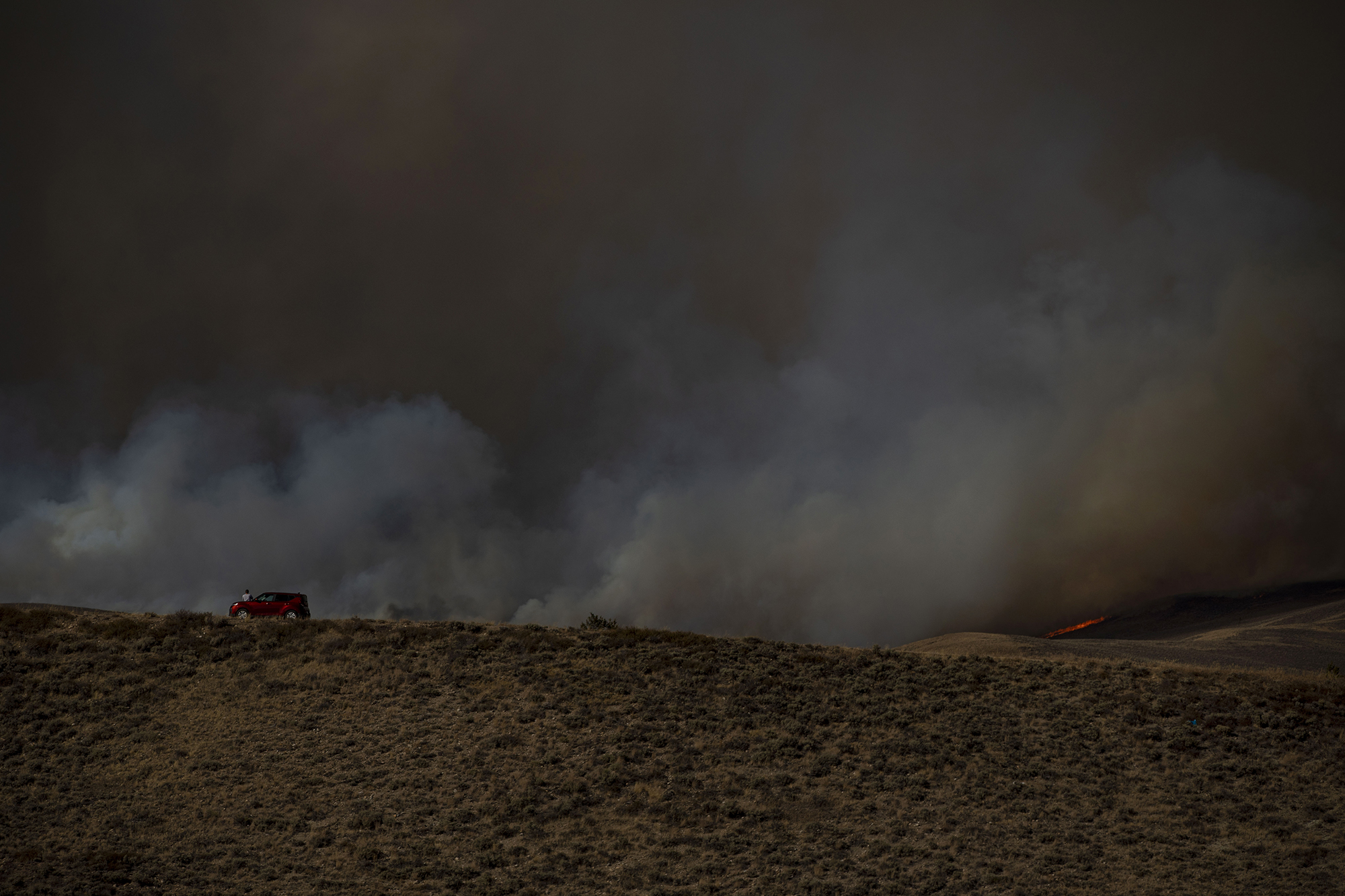 Zach Szloboda watches the East Troublesome fire burn along the ridge in Granby, Colo., in Grand County on Thursday, Oct. 22, 2020. The East Troublesome fire has grown to be the second-largest wildfire in Colorado history. (Chancey Bush/ The Gazette) (Chancey Bush The Gazette)