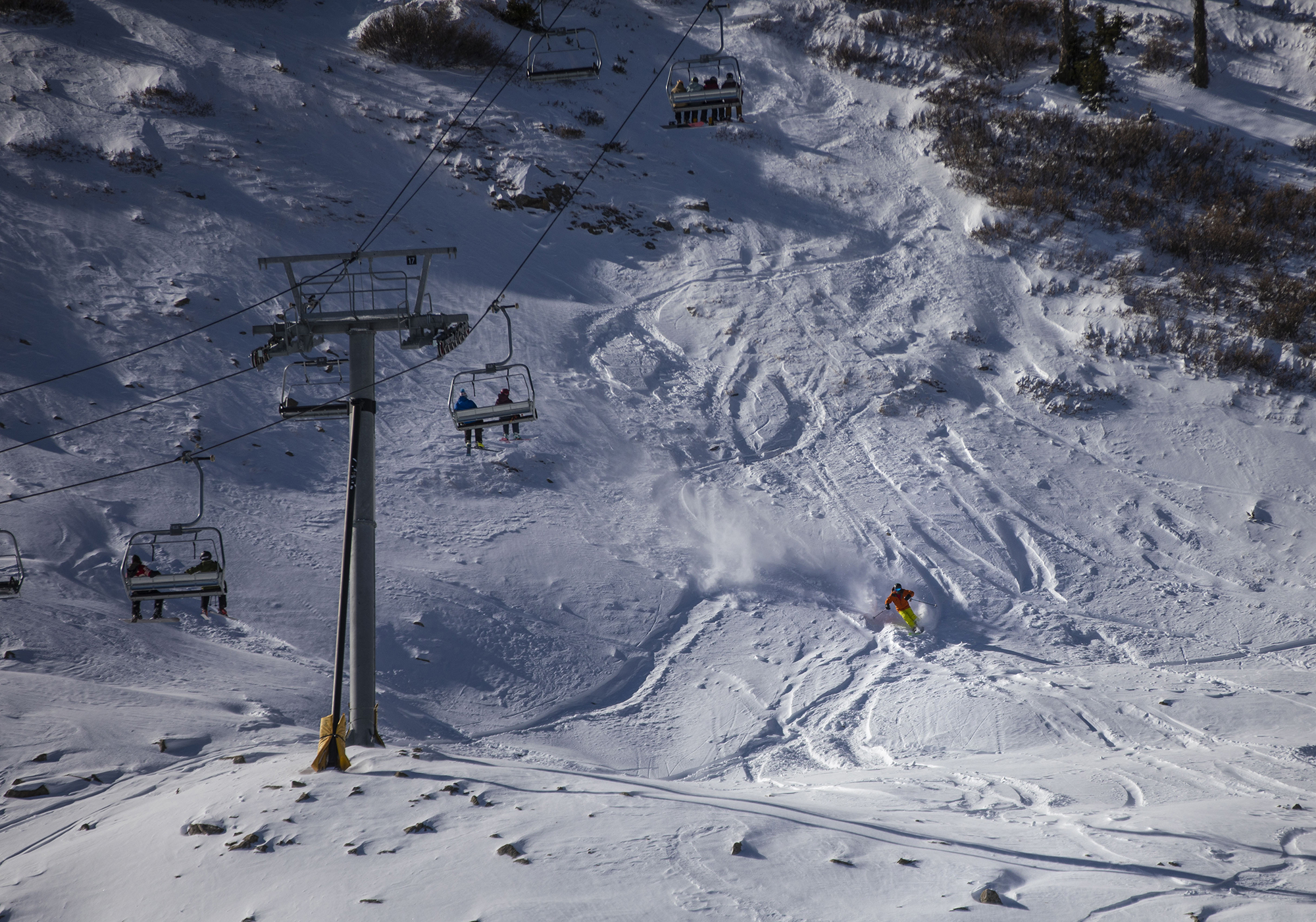 A skier cuts through the snow near the Treasure ski lift at Wolf Creek Ski Area in Colorado on Wednesday, Oct. 28, 2020. Wolf Creek is the first ski area in Colorado to open for the 2020-21 season, with a snow total of 24 inches. Treasure, Bonanza and Nova lifts are in full operation. Due to COVID-19, all indoor facilities are closed, excluding bathrooms, social distancing and wearing of masks are required. (Chancey Bush/ The Gazette) (Chancey Bush The Gazette)