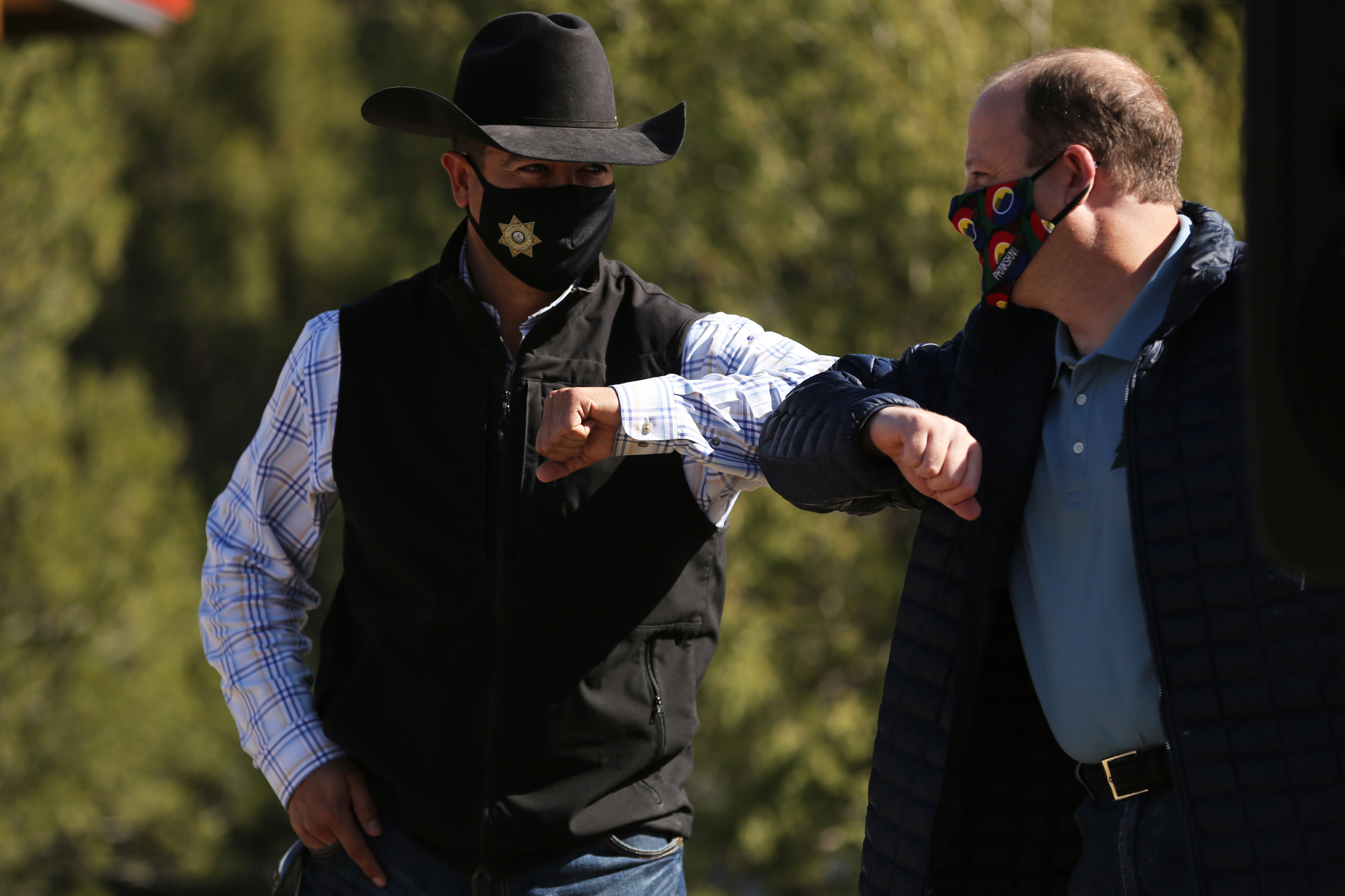 Colorado State Representative Donald Valdez, with House District 62, elbow bumps Colorado Governor Jared Polis, right, at the grand opening of Fishers Peak State Park near Trinidad, Colorado on Oct. 30, 2020. The opening of the state park required collaboration between state legislators, local property owners and non-governmental organizations. (Forrest Czarnecki/The Gazette) (Forrest Czarnecki)