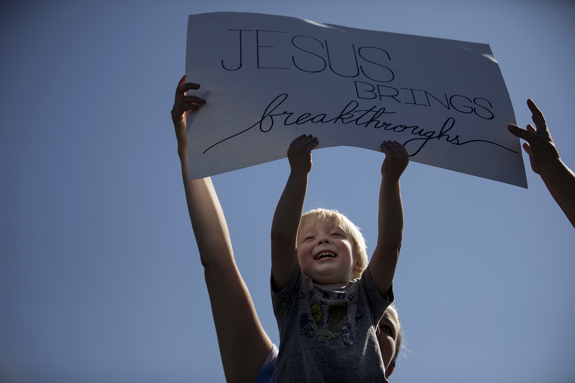 Bentley Cobler, 3, sits on his mother Megan Lucken's shoulders during the