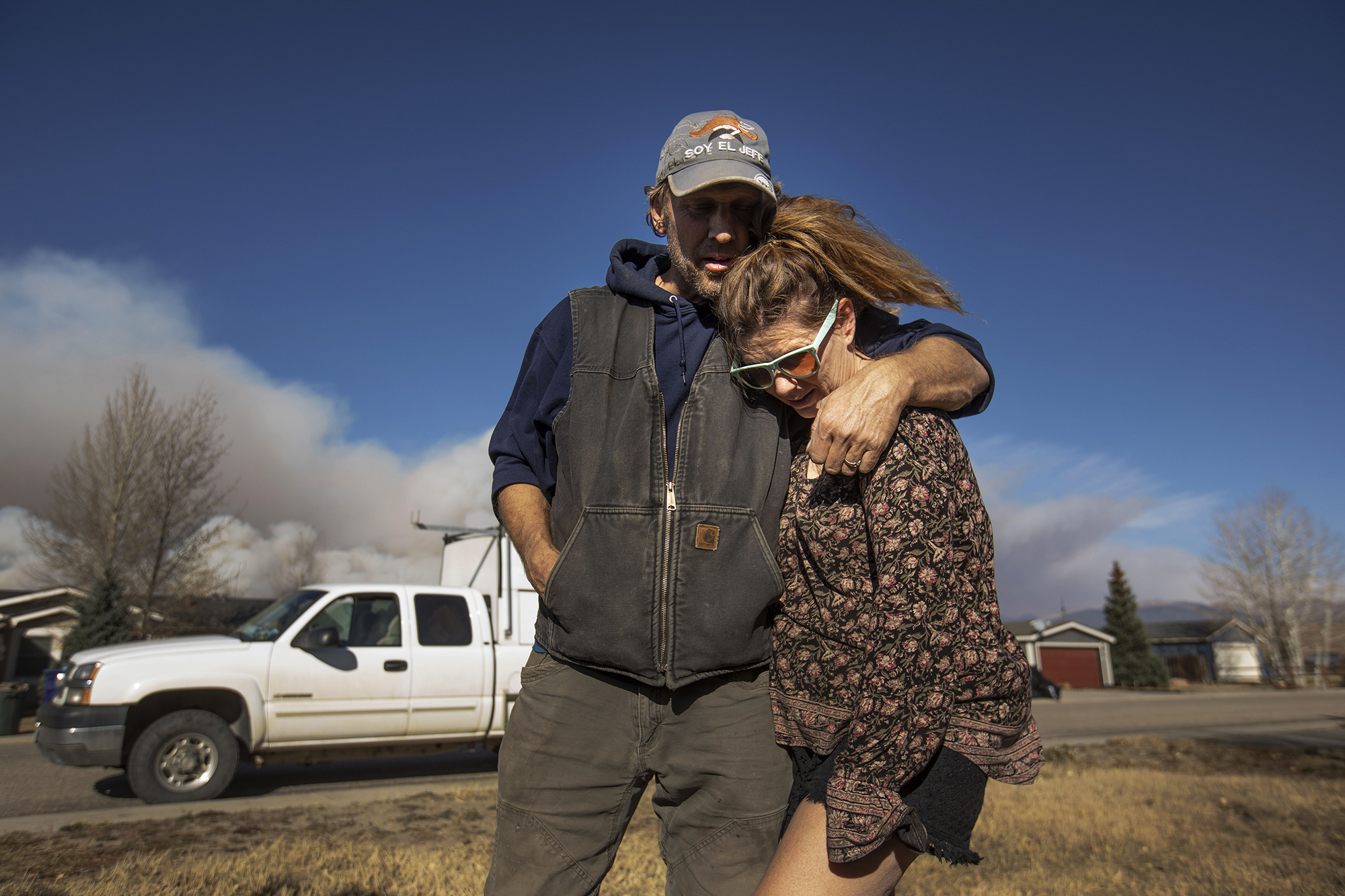 Koll Gardner hugs his wife Natalie Gardner goodbye at their home in Granby after they packed the car with their belongings and evacuate due to the East Troublesome fire in Grand County on Thursday, Oct. 22, 2020. (Chancey Bush/ The Gazette) (Chancey Bush The Gazette)