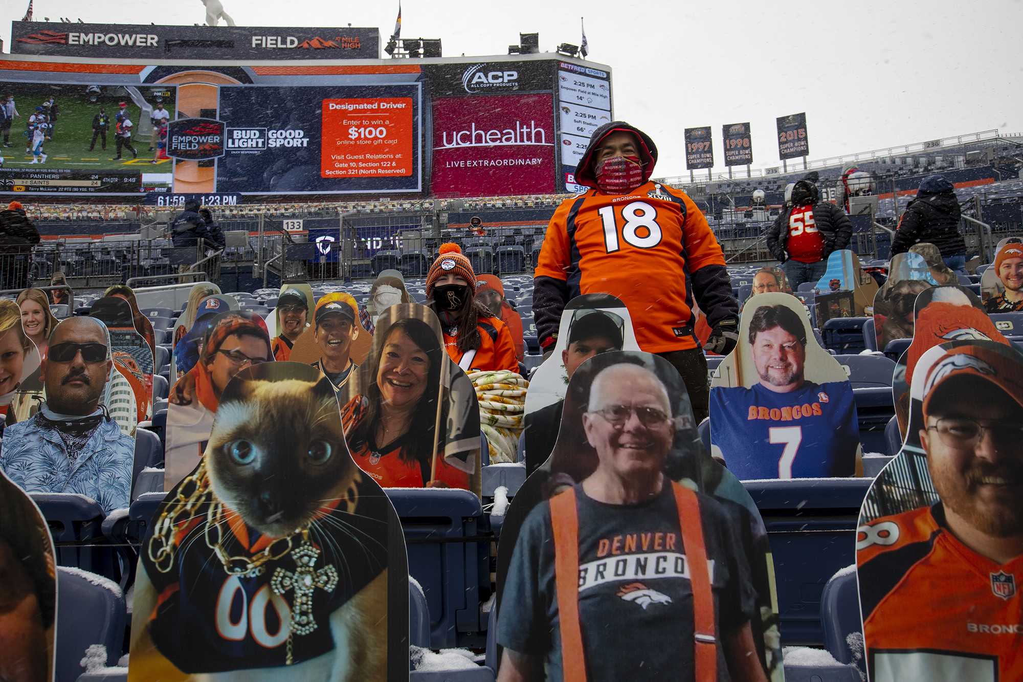 Alana Linford, left, and Joel Montoya, right, sit among fan cutouts in the stands before the start of the Denver Broncos home game against the Kansas City Chiefs at Empower Field at Mile High in Denver, Colo., on Sunday, Oct. 25, 2020. (Chancey Bush/ The Gazette) (Chancey Bush The Gazette)