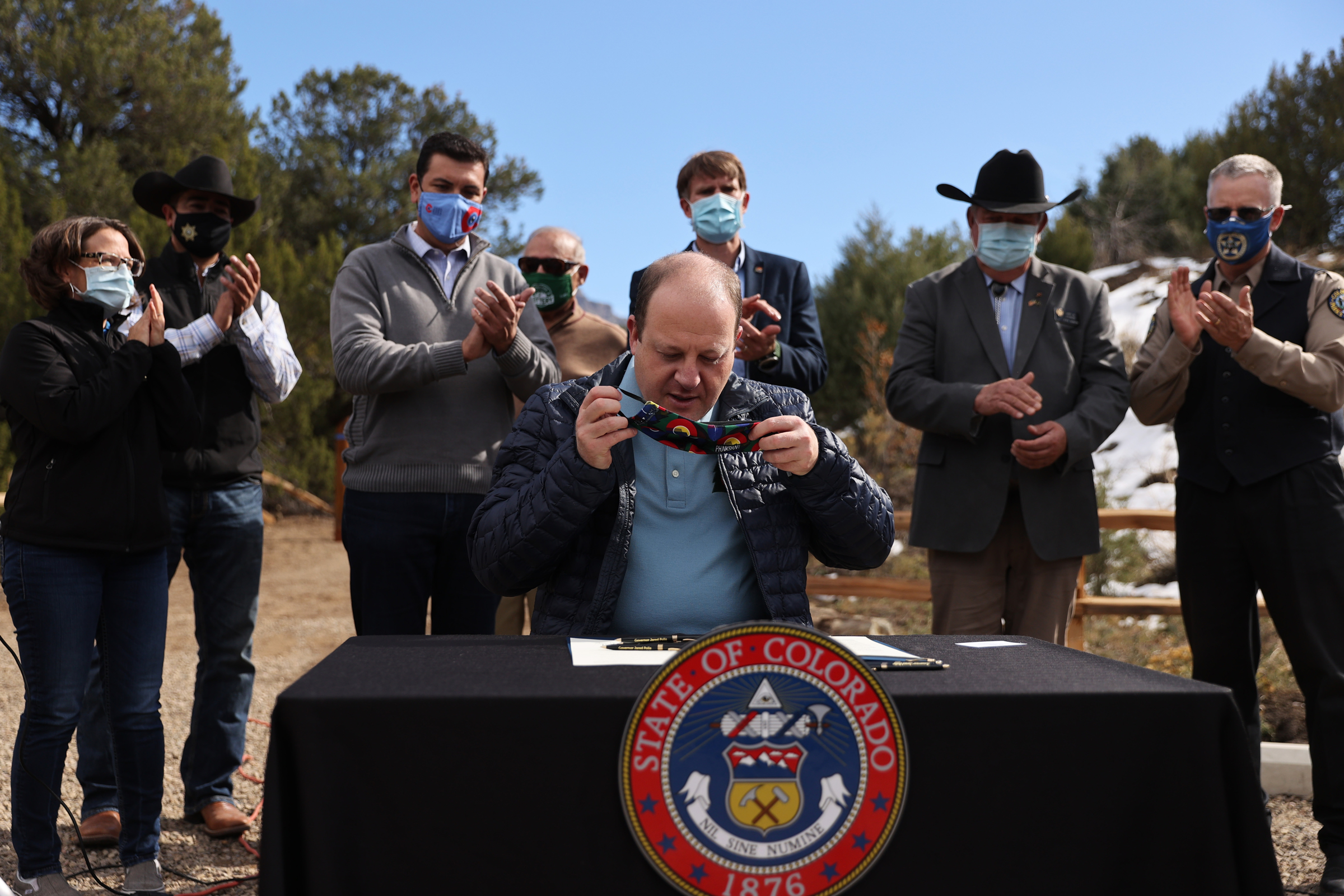 Colorado Governor Jared Polis puts his mask back on after signing an executive order at the grand opening of Fishers Peak State Park near Trinidad, Colorado on Oct. 30, 2020. Fishers Peak is the 42nd state park in Colorado, and is also one of the largest at over 19,000 acres in size. (Forrest Czarnecki/The Gazette) (Forrest Czarnecki)