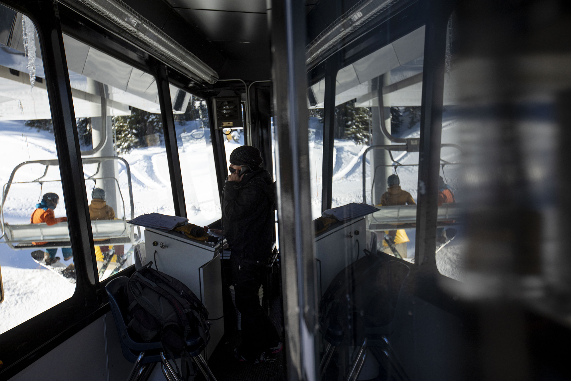 Sunshine Blue takes a call inside the Treasure ski lift at Wolf Creek Ski Area in Colorado on Wednesday, Oct. 28, 2020. Wolf Creek is the first ski area in Colorado to open for the 2020-21 season, with a snow total of 24 inches. Treasure, Bonanza and Nova lifts are in full operation. Due to COVID-19, all indoor facilities are closed, excluding bathrooms, social distancing and wearing of masks are required. (Chancey Bush/ The Gazette) (Chancey Bush The Gazette)
