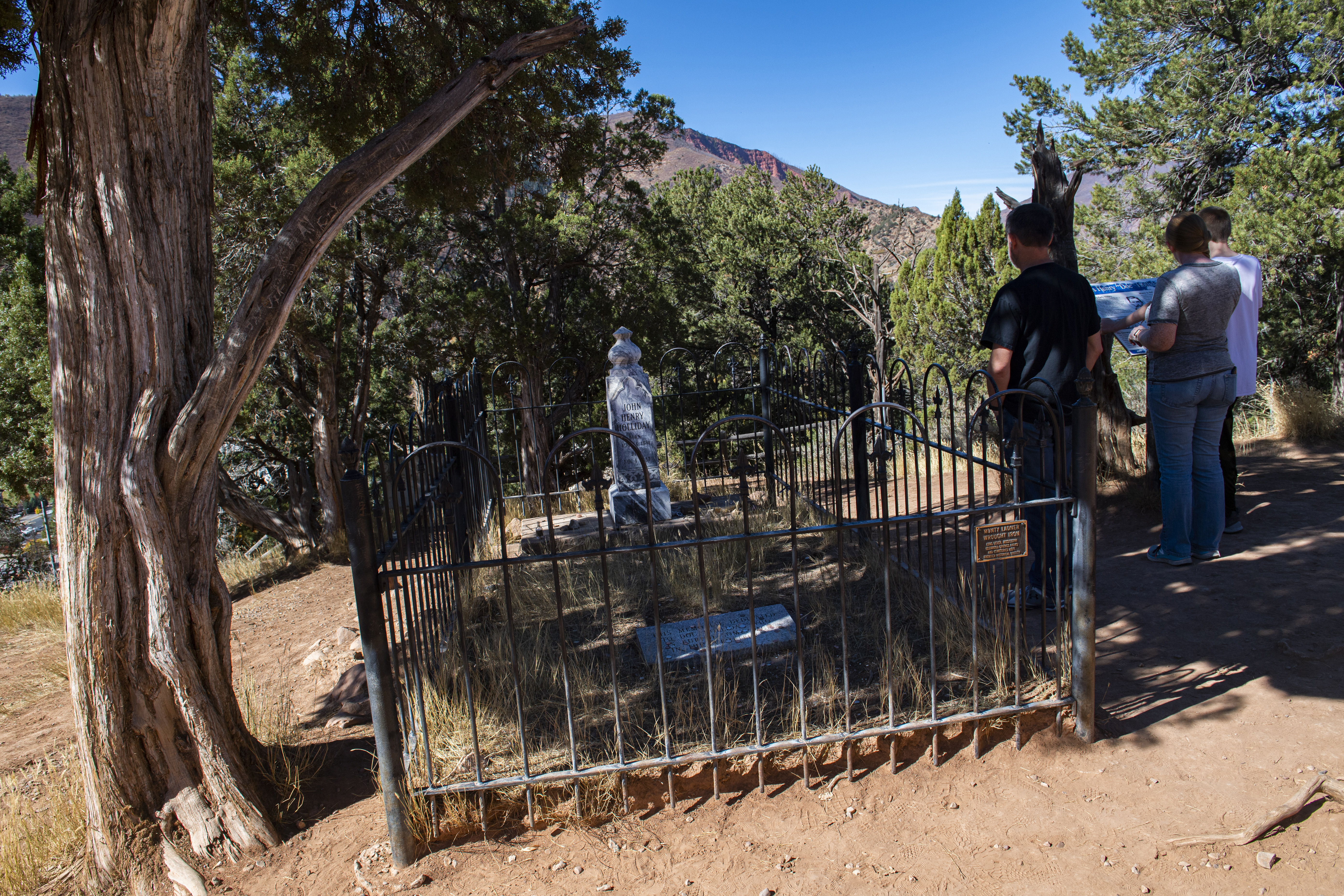 Visitors read about Doc Holliday while visiting his grave marker at the Linwood Cemetery, Oct. 13, 2020, in Glenwood Springs. (Christian Murdock, Gazette file)