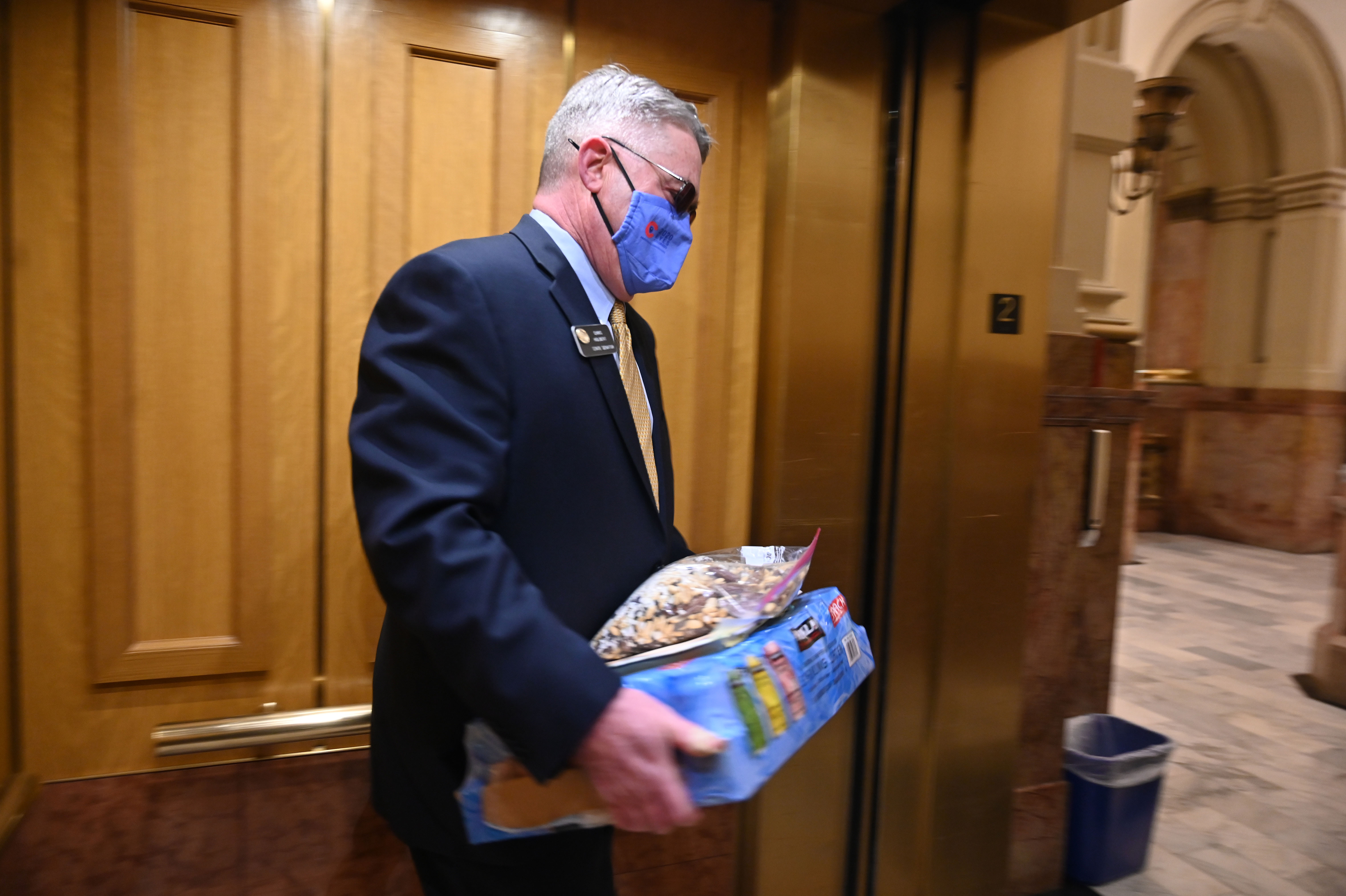 Colorado Senator Chris Holbert, Republican Senate Minority Leader, carries in provisions of trail mix and water for the special session that will last at least three days at the Capitol. Monday, Nov. 30, 2020. (JERILEE BENNETT, The Gazette)