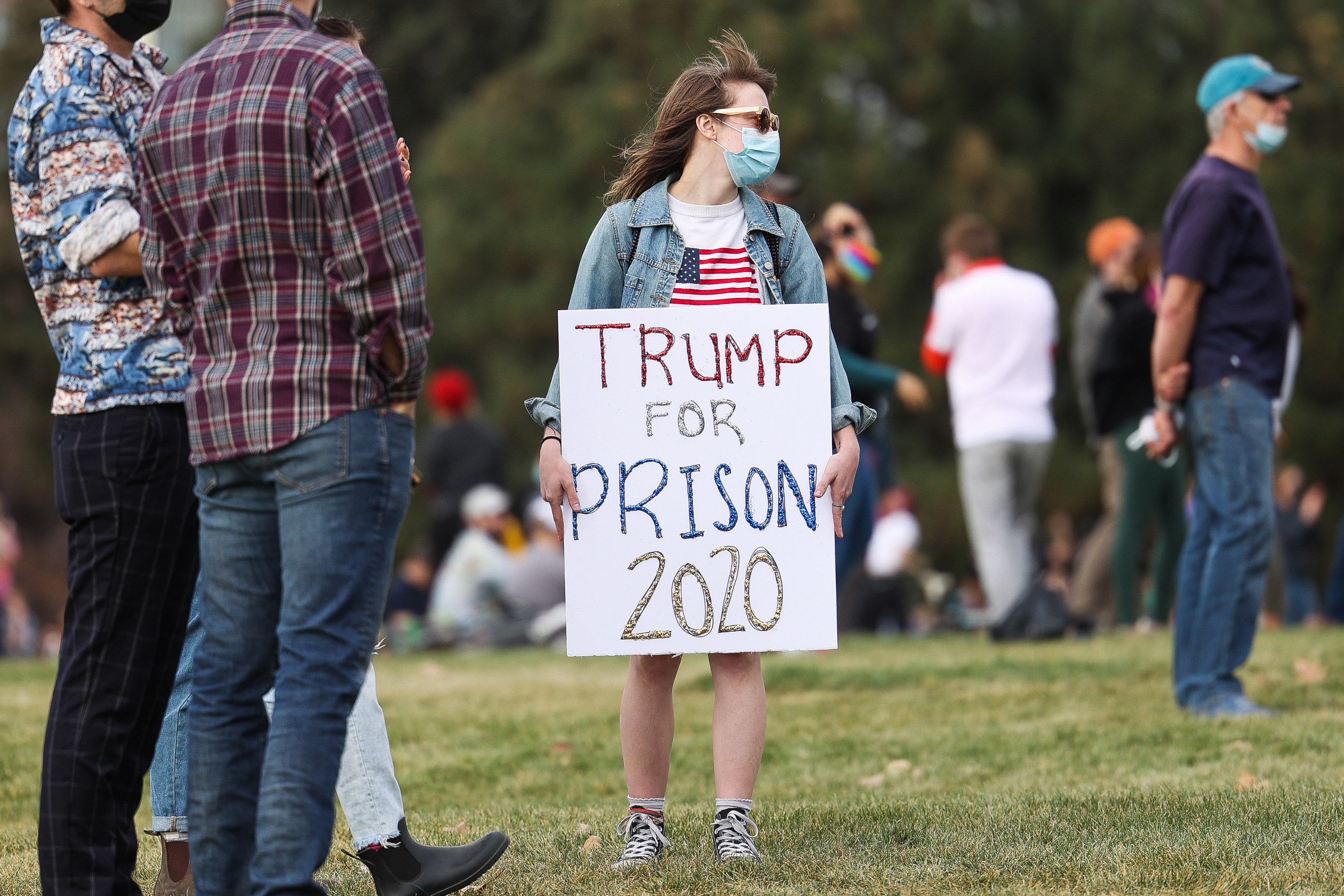 A woman holds a, “Trump for prison 2020” sign as people celebrate the announcement that Joe Biden was elected as the next president of the United States according to multiple news sources Saturday, Nov. 7, 2020 at Cheeseman Park in Denver. (Michael Ciaglo/Special to The Denver Gazette) (Michael Ciaglo/Special to The De)