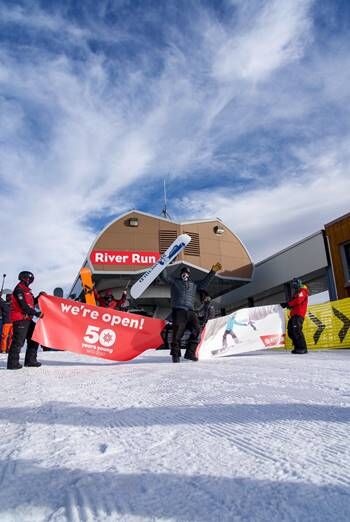 Summit County’s infamous Nate Dogggg breaks the banner at the top of River Run Gondola. (Bryce Metzger, Keystone Resort)