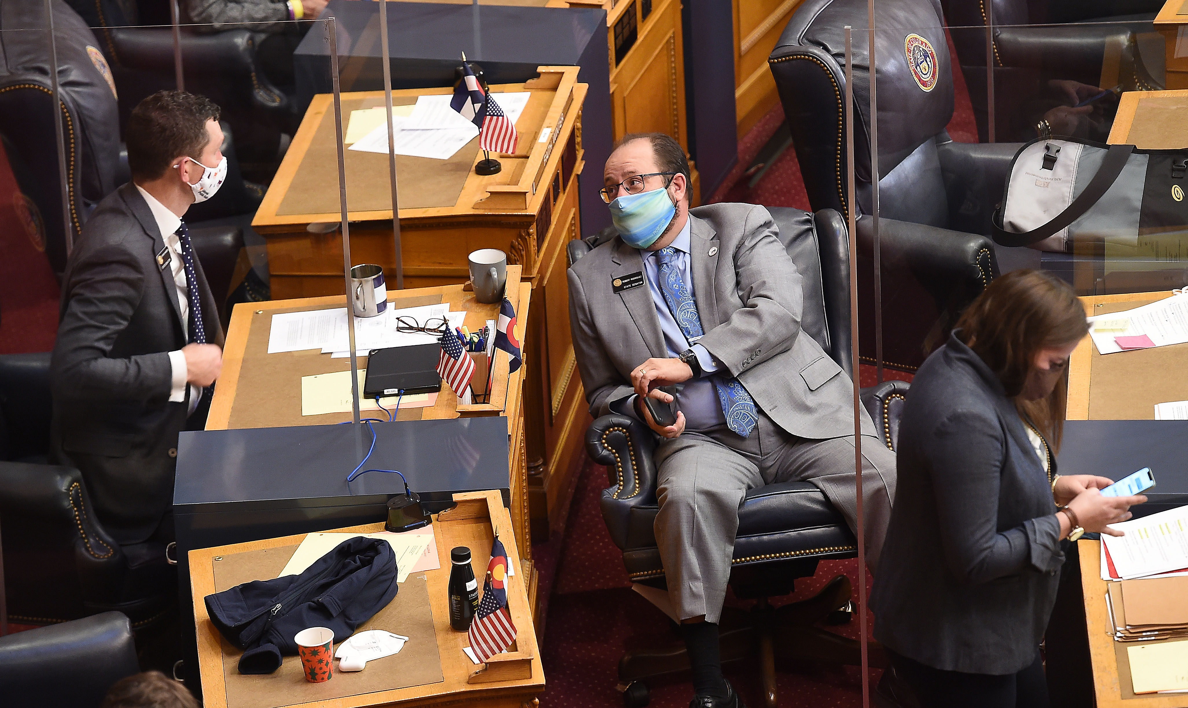 State lawmakers returned to the Capitol on Monday for a special session to work on bills tied to COVID-19. State Senators Chris Hansen and Robert Rodriguez, Democrats, left to right, talk during a recess on the Senate floor on Monday, Nov. 30, 2020. (JERILEE BENNETT, The Gazette)