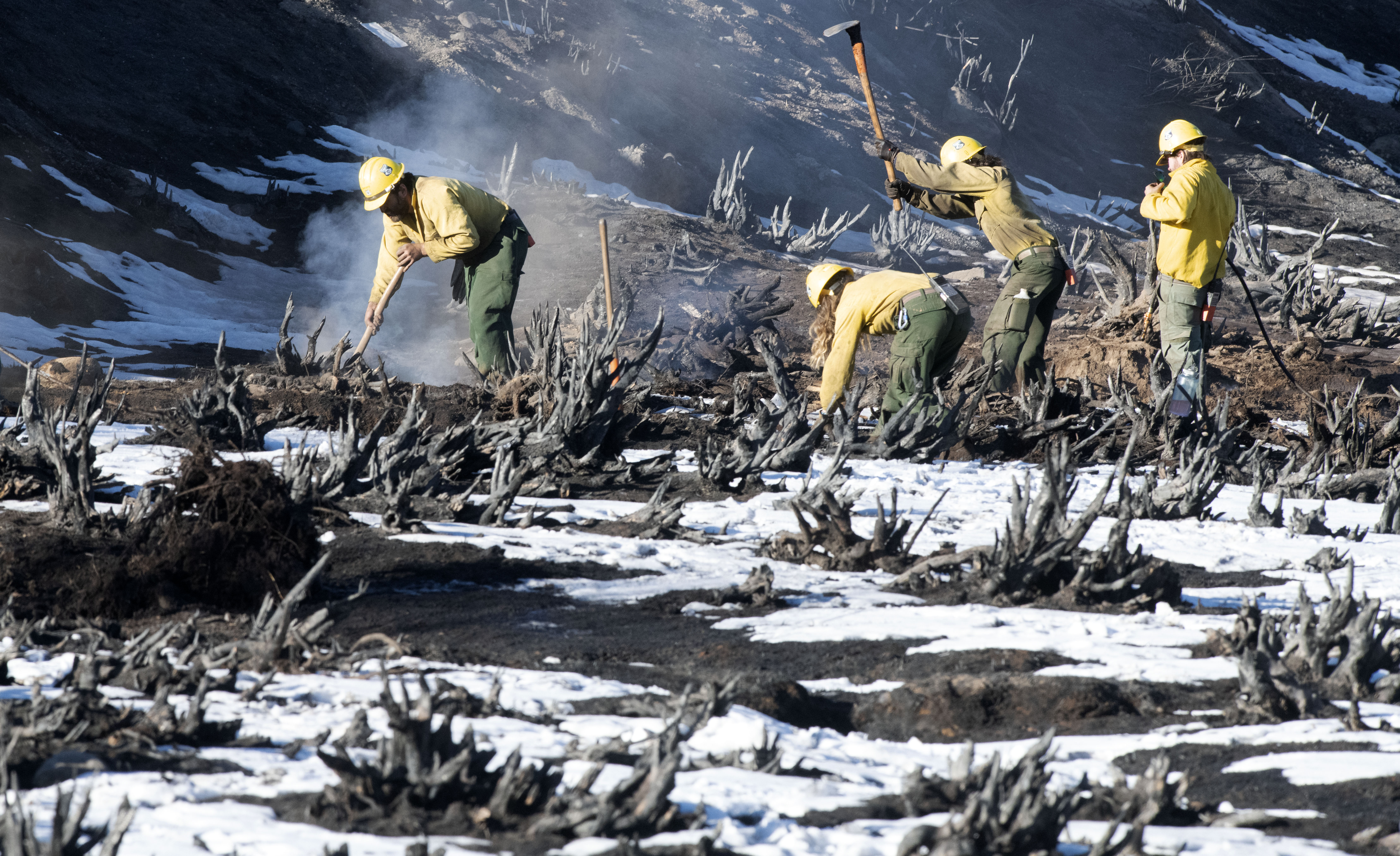 Although the nearly 8 inches of snow that fell near Grand Lake, Colorado, was able to substantially slow down the East Troublesome Fire the fire can still smolder underneath the snow. Firefighters from Oregon knock down smoldering stumps near Grand Lake on Sunday, Nov. 1, 2020. (Photo by Jerilee Bennett, The Gazette) (JERILEE BENNETT, THE GAZETTE)