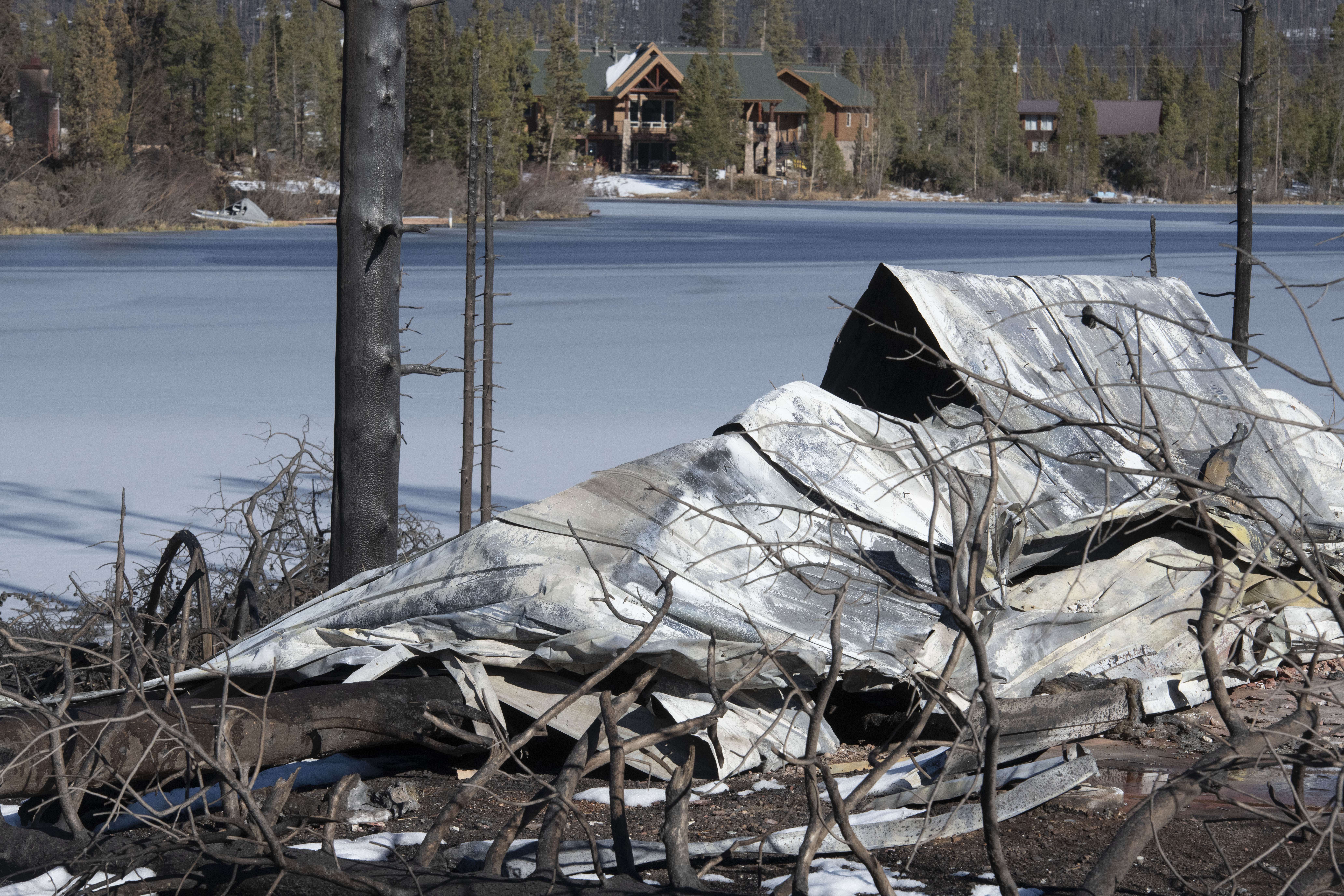 Rubble from a home in the Sun Valley subdivision near Grand Lake, Colorado is across a lake from a home that was spared. The East Troublesome Fire was substantially slowed down last week after quickly becoming on of the largest wildfires in Colorado history overnight. Sunday, Nov. 1, 2020. (Photo by Jerilee Bennett, The Gazette) (JERILEE BENNETT, THE GAZETTE)