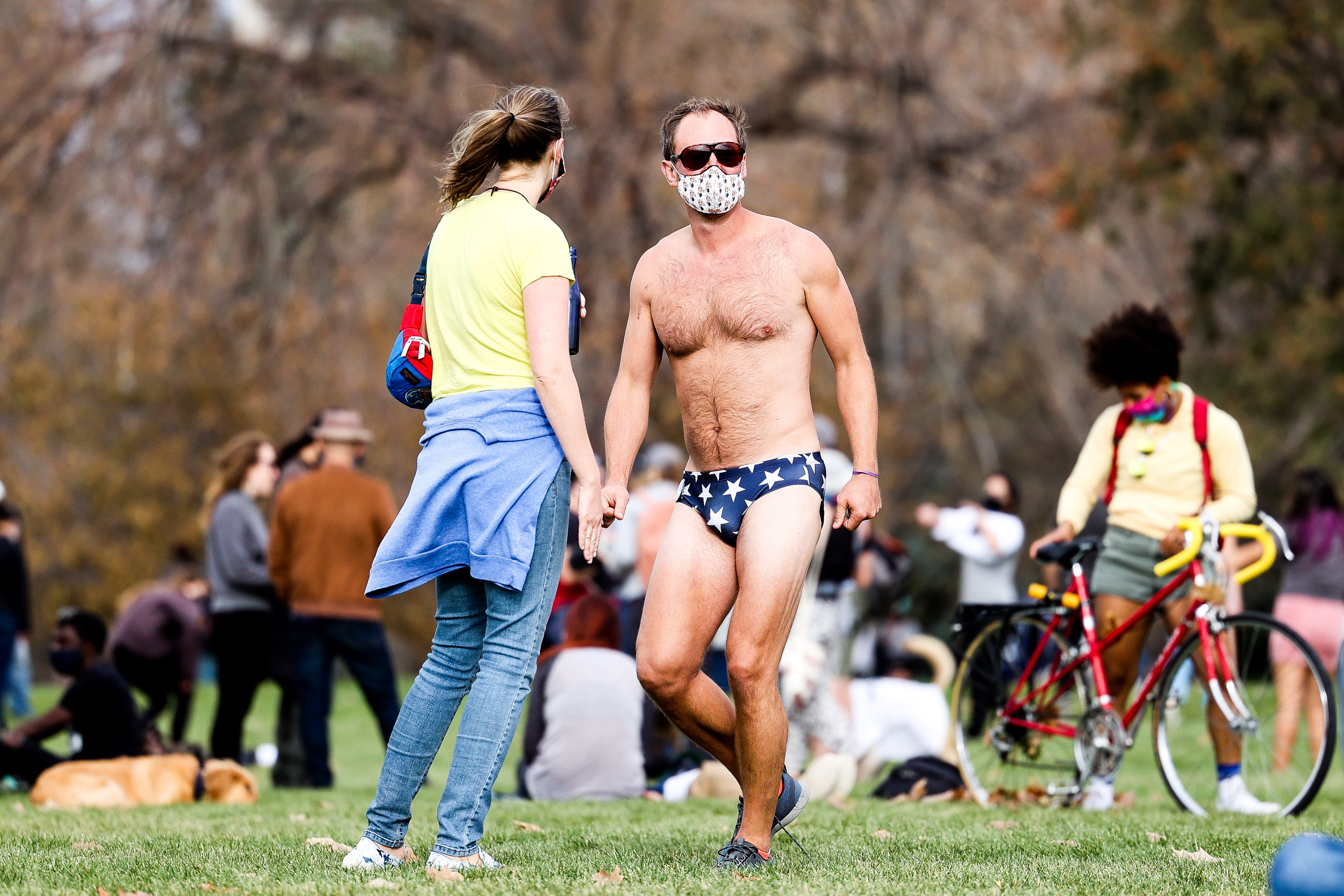 A man in a speedo dances as people celebrate the announcement that Joe Biden was elected as the next president of the United States according to multiple news sources Saturday, Nov. 7, 2020 at Cheeseman Park in Denver. (Michael Ciaglo/Special to The Denver Gazette) (Michael Ciaglo/Special to The De)
