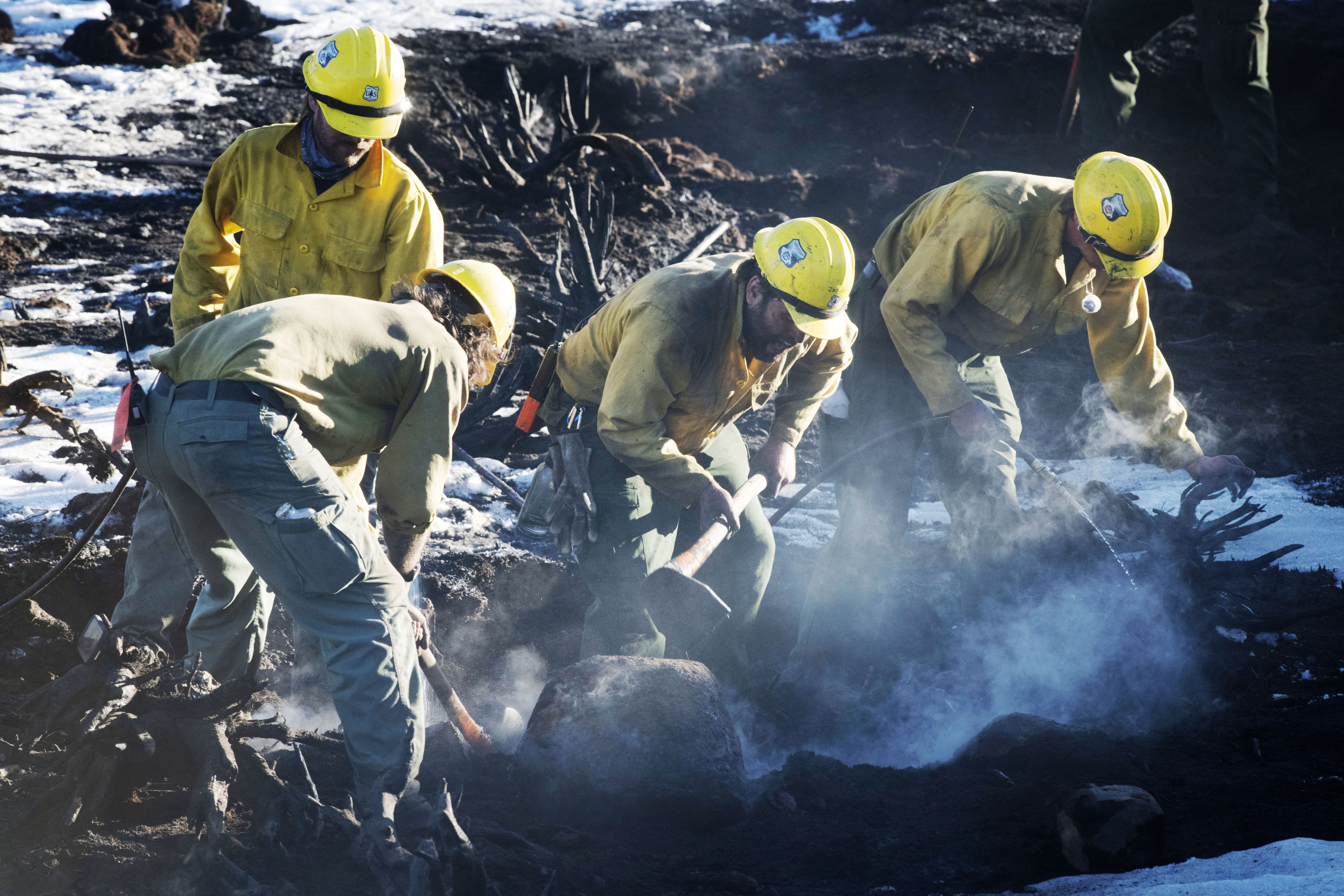 Although the nearly 8 inches of snow that fell near Grand Lake, Colorado, was able to substantially slow down the East Troublesome Fire the fire can still smolder underneath the snow. Firefighters from Oregon knock down smoldering stumps near Grand Lake on Sunday, Nov. 1, 2020. (Photo by Jerilee Bennett, The Gazette) (JERILEE BENNETT, THE GAZETTE)