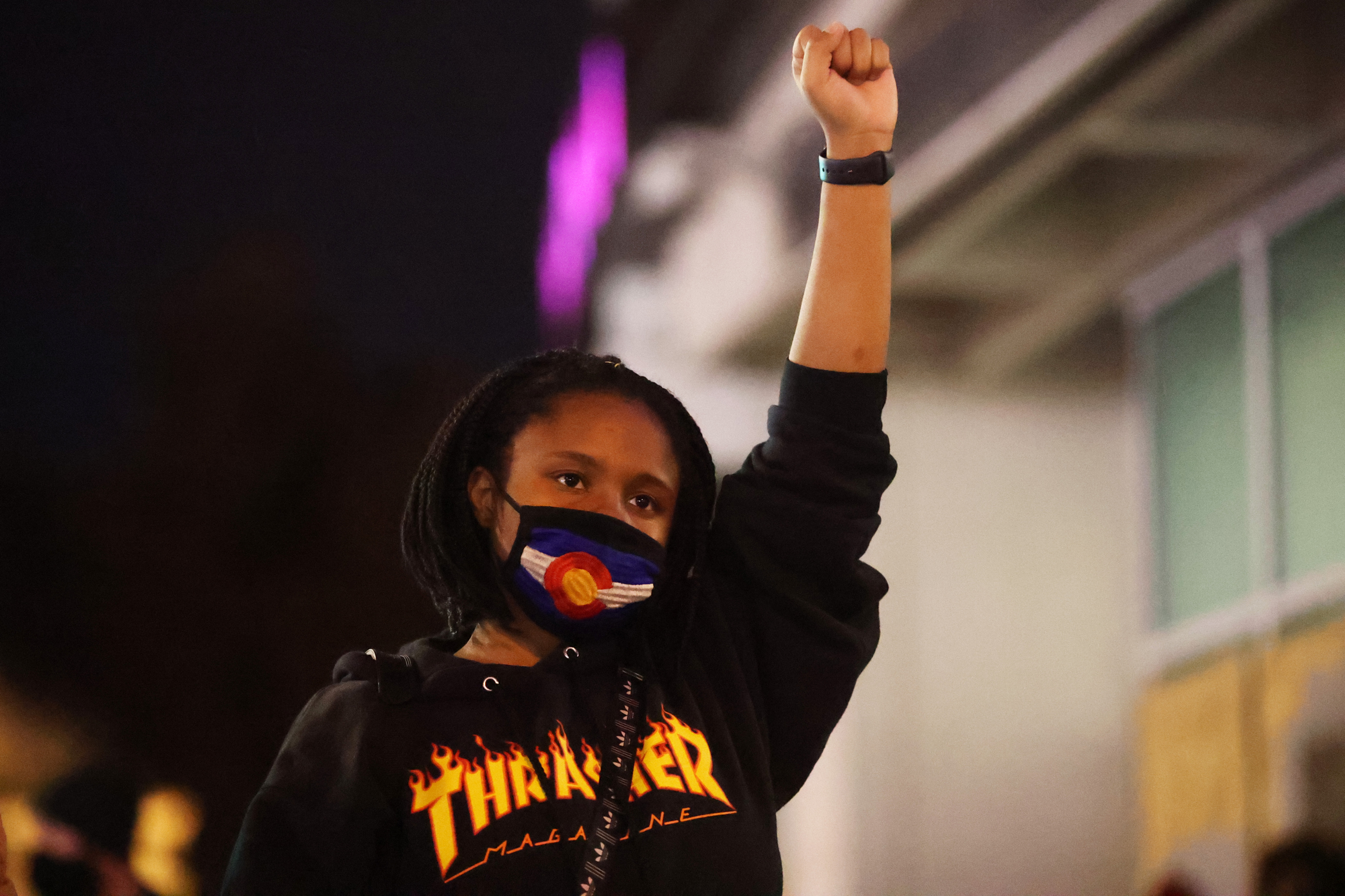 A young woman raises her fist while the names of black people killed by police in the United States during a peaceful march in downtown Denver on Nov. 6, 2020. (Forrest Czarnecki/The Gazette) (Forrest Czarnecki)