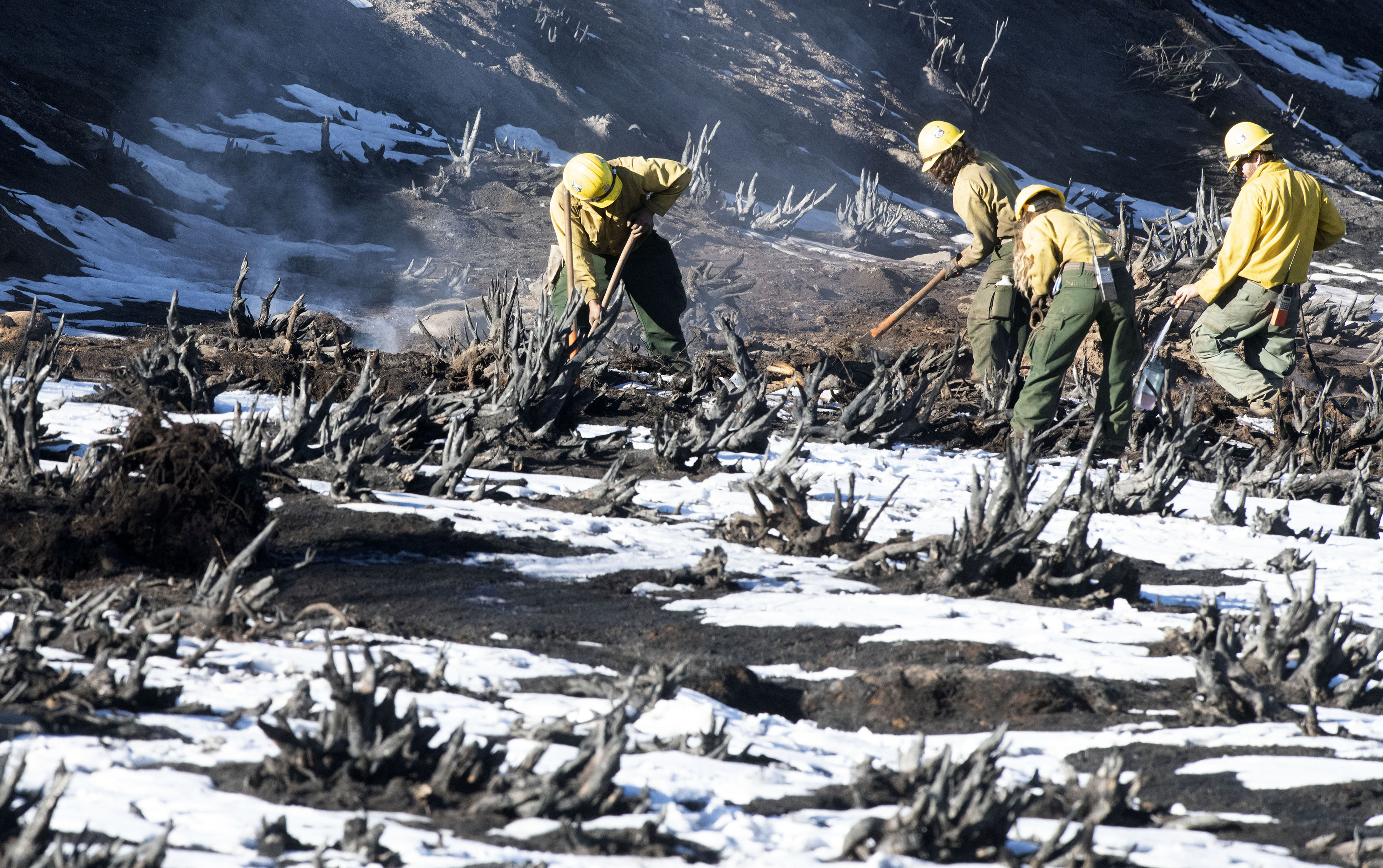 Although the nearly 8 inches of snow that fell near Grand Lake, Colorado, was able to substantially slow down the East Troublesome Fire the fire can still smolder underneath the snow. Firefighters from Oregon knock down smoldering stumps near Grand Lake on Sunday, Nov. 1, 2020. (Photo by Jerilee Bennett, The Gazette) (JERILEE BENNETT, THE GAZETTE)