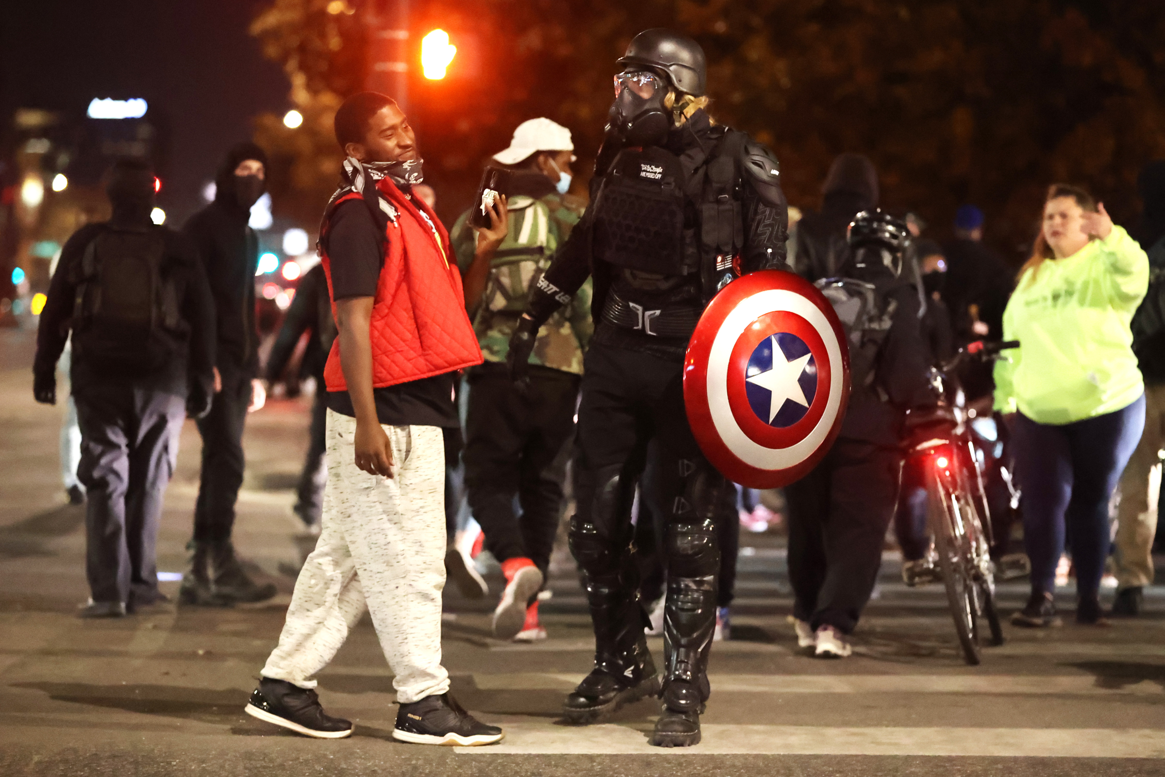 Protestors, one of whom is dressed in combat gear with a Captain America shield, block traffic at the intersection of Colfax Avenue and Broadway Street while marching through downtown Denver on Nov. 6, 2020. (Forrest Czarnecki/The Gazette) (Forrest Czarnecki)