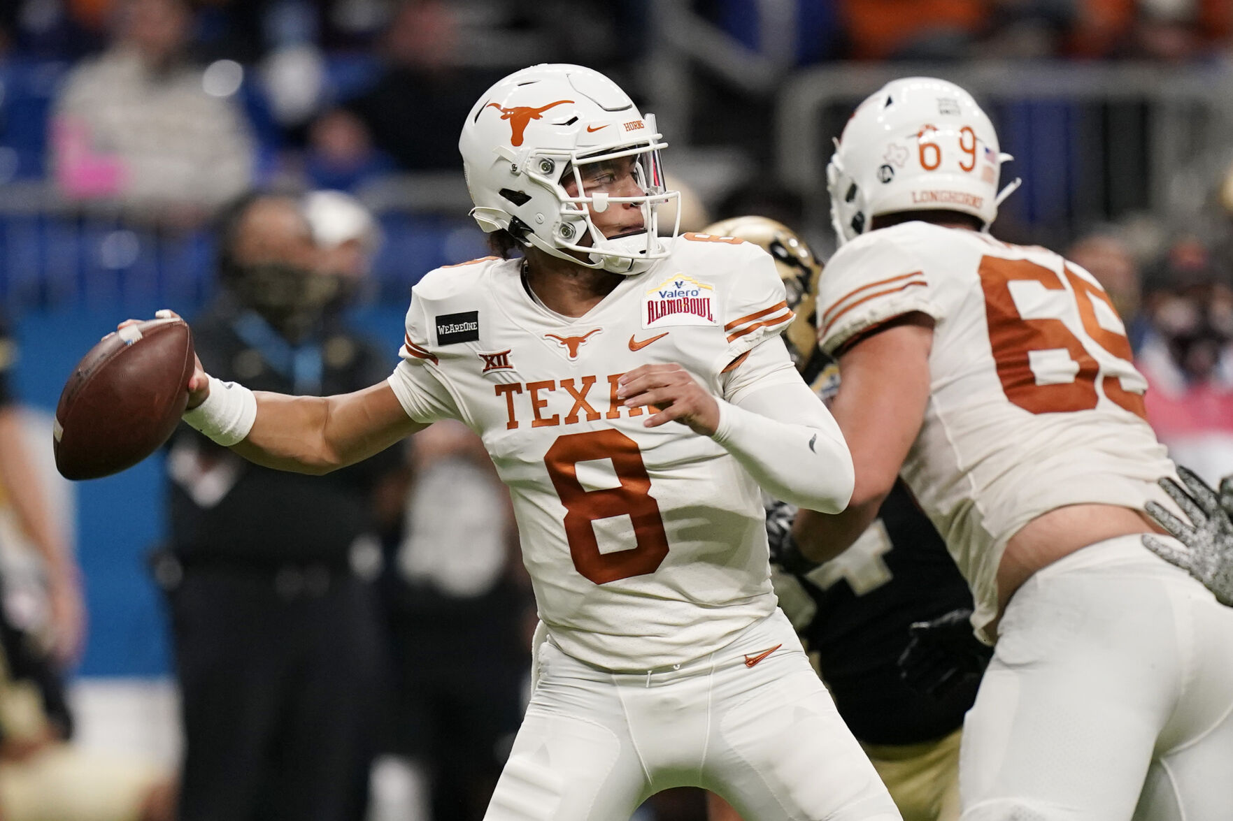 Texas quarterback Casey Thompson (8) looks for a receiver during the second half of the team's Alamo Bowl NCAA college football game against Colorado, Tuesday, Dec. 29, 2020, in San Antonio. (AP Photo/Eric Gay) (Eric Gay)