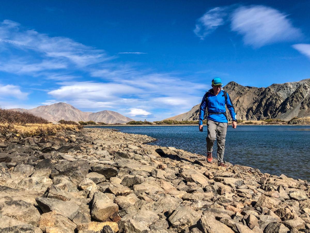 The Helly Hansen LIFA Merino lightweight hoodie being utilized at an alpine lake in Colorado. Photo Credit: Spencer McKee.