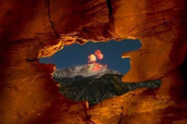 The AdAmAn Club shot off fireworks from the summit of Pikes Peak to welcome in the New Year at midnight , Jan. 1, 2010, as seen through the Siamese Twins rock formation in Garden of the Gods. (Mark Reis, The Gazette file) (The Gazette file)