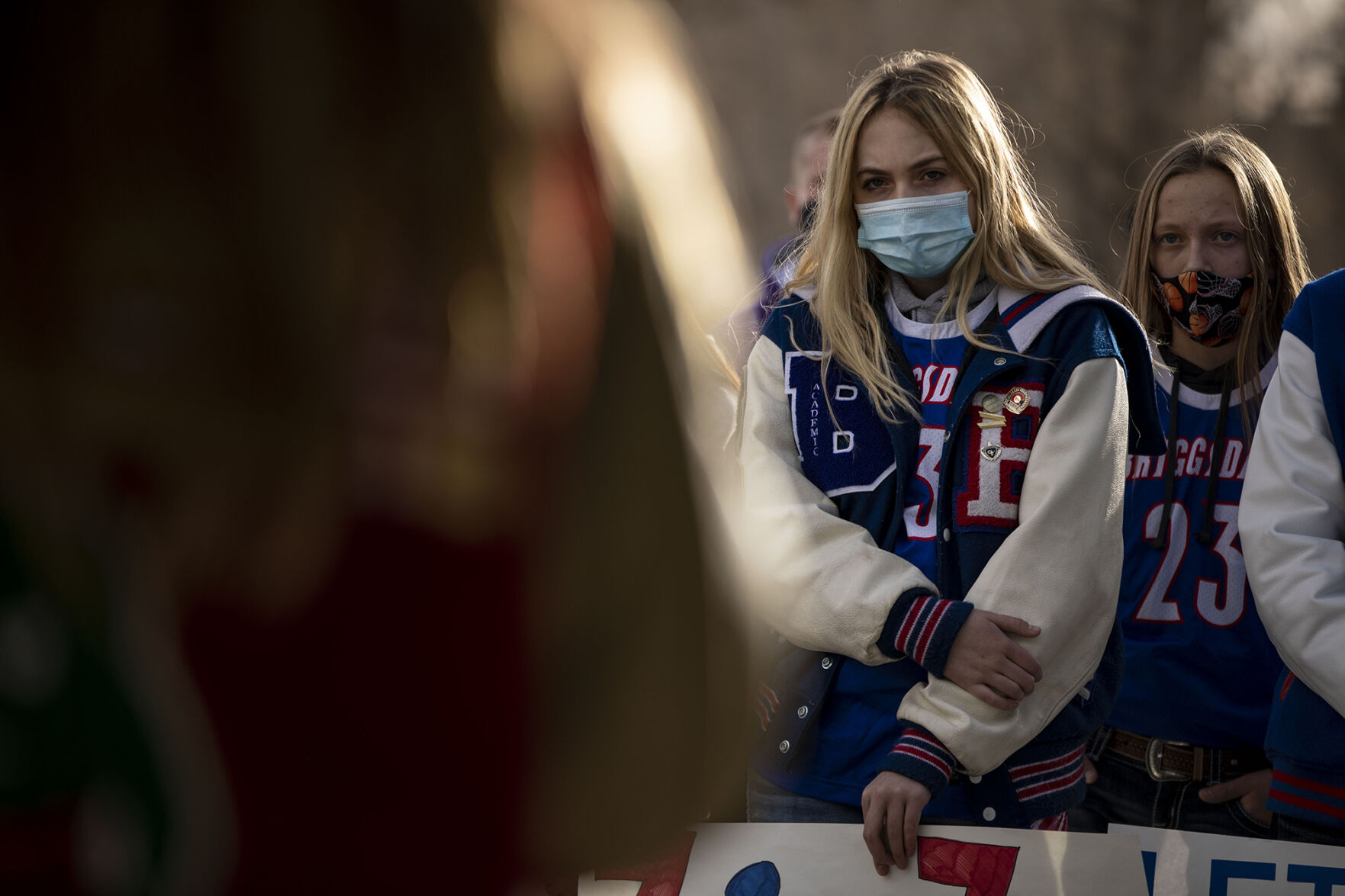 Briggsdale junior Kylie Krise listens to athletes speak about how the postponement of sports is affecting them during the LetCOPlay protest at Creekside Park, across from the office of the Colorado Department of Public Health and Environment, in Glendale, Colo., on Thursday, Dec. 17, 2020. Students, parents and coaches participated in response to the CDPHE postponement of high school winter sports. (Chancey Bush/ The Gazette) (Chancey Bush)