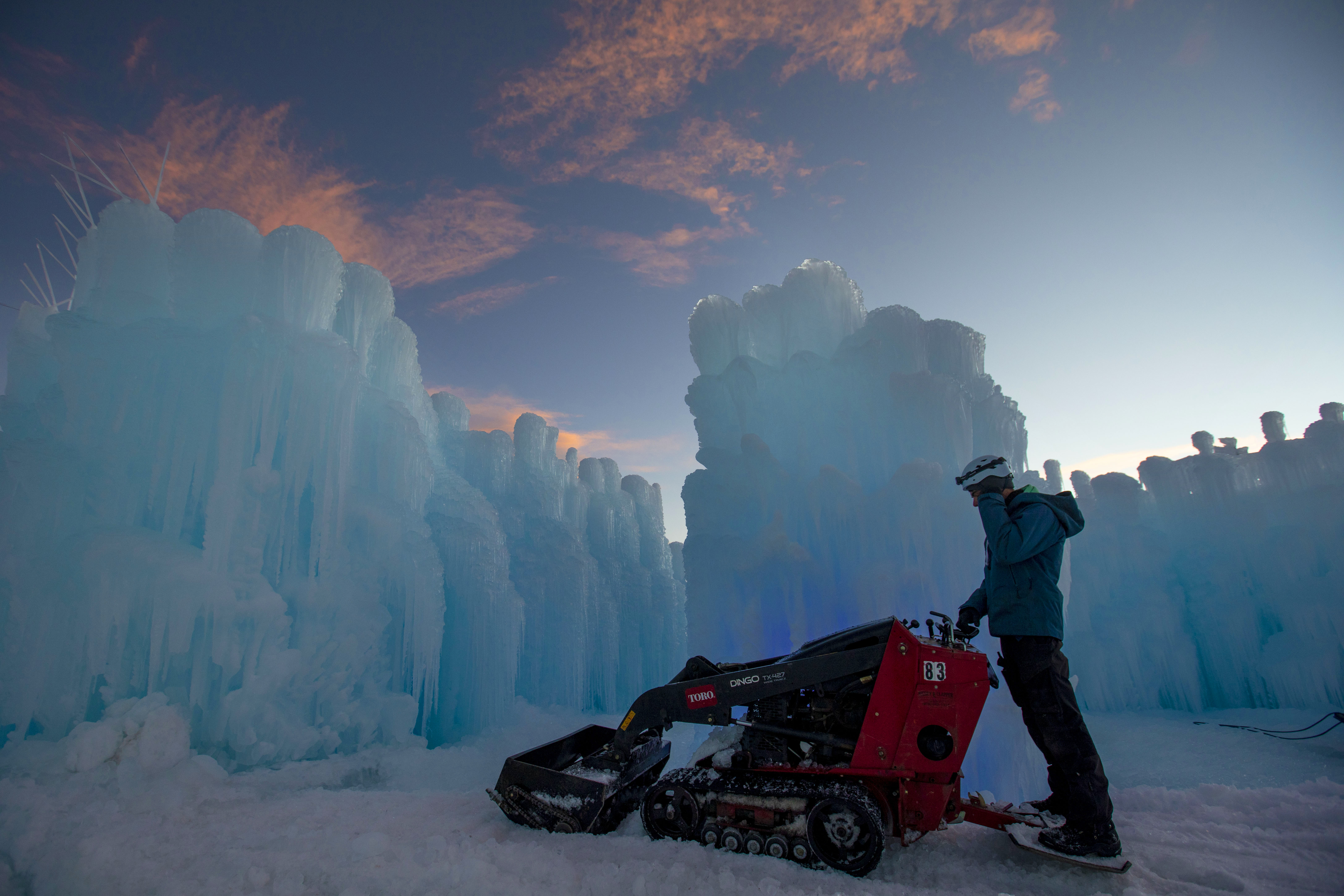 Ethan Jacobson uses equipment to grade snow and ice inside the Dillon Ice Castles in Dillon, Colo., on Wednesday, Dec. 9, 2020. Ice artisans spend around six weeks placing up to 10,000 icicles each day to create the life-size winter fairytale built entirely from ice.The Ice Castles return for the fourth year with limited capacity due to the COVID-19 pandemic. The Ice Castles are expected to open around Christmas. (Chancey Bush/ The Gazette) (Chancey Bush/ The Gazette)