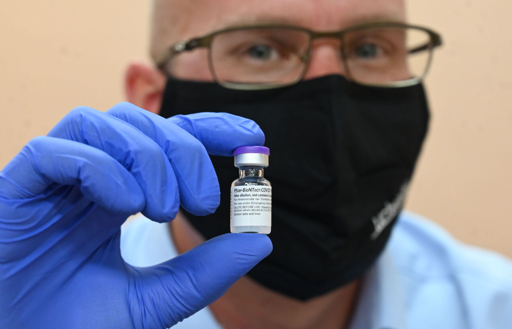 Pharmacist Chris Martin with UCHealth holds a vial of the COVID-19 vaccine in Colorado Springs. The Gazette file. (THE GAZETTE)